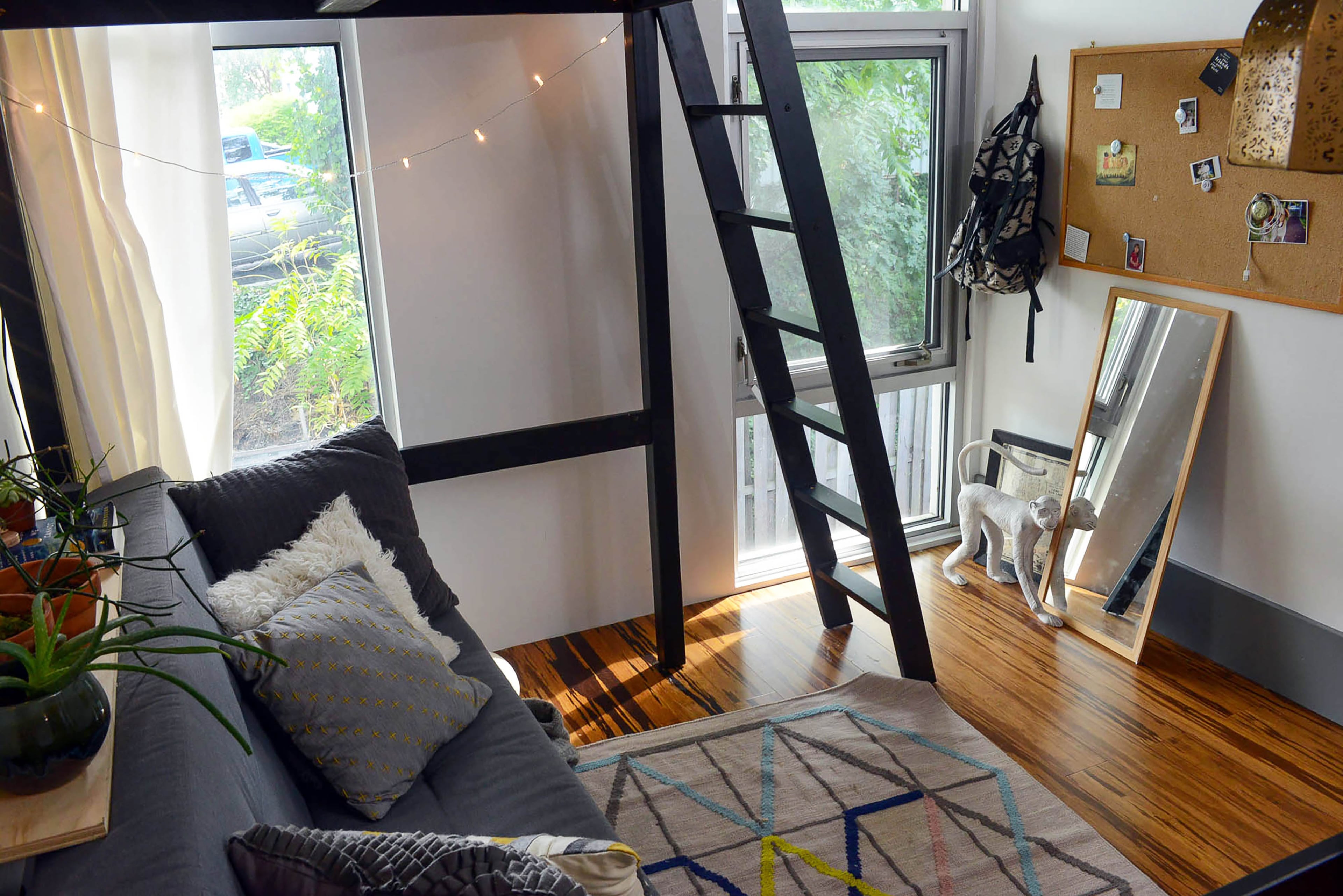 The dorm-like room features fun details such as a geometric rug and monkey statue. Large rectangular windows let in natural light. Two kids' bedrooms and a communal space upstairs were among $45,000 of renovations in 2016. Christopher Oquendo/AJC FILE