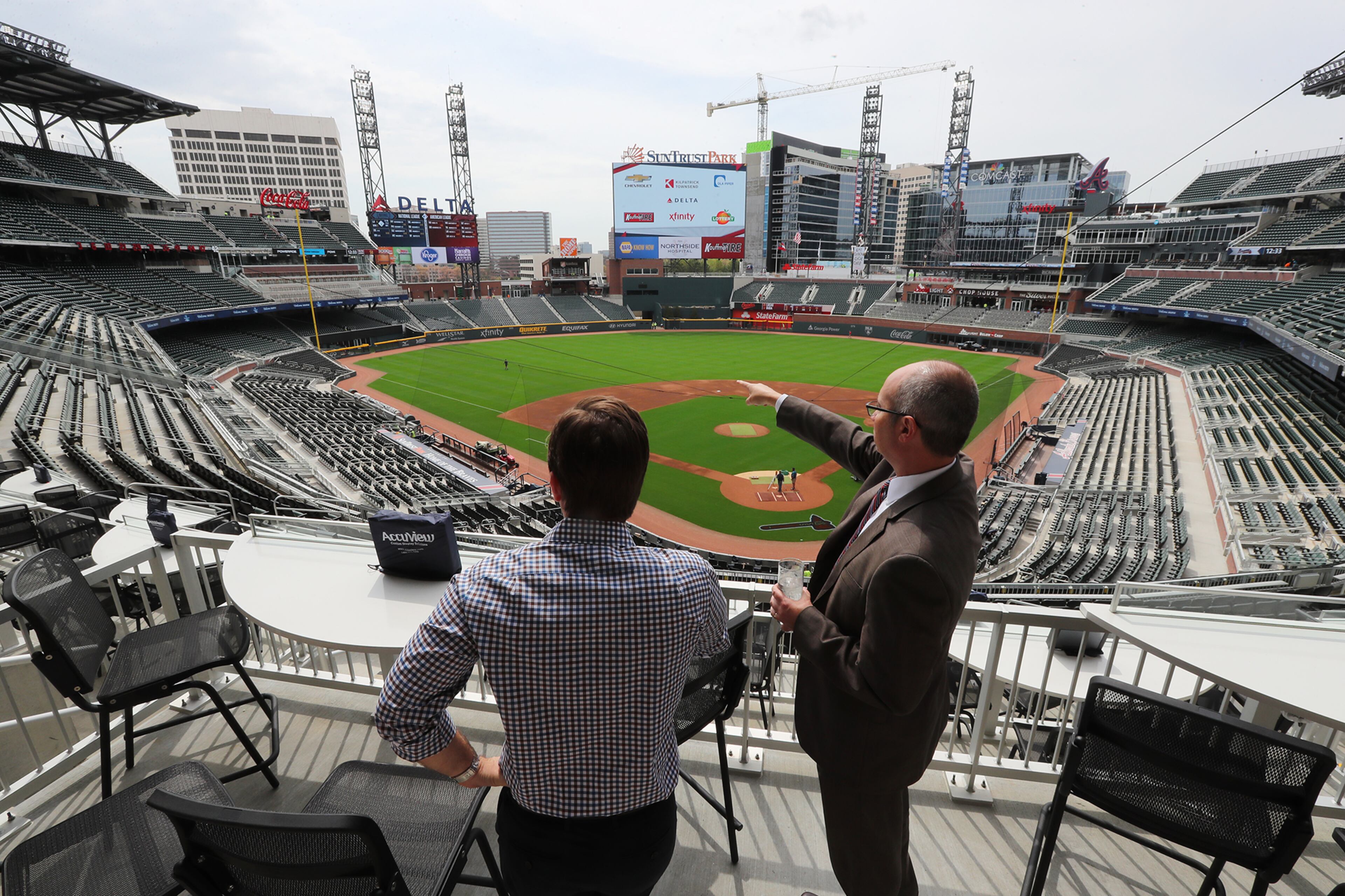 March 30, 2017, Atlanta: Baseball fans Nick Rueter (left) and Matthew Clarke take in the view from the upper decks during the Leadoff Reception at the Infiniti Club in SunTrust Park on Thursday, March 30, 2017, in Atlanta. Curtis Compton/ccompton@ajc.com