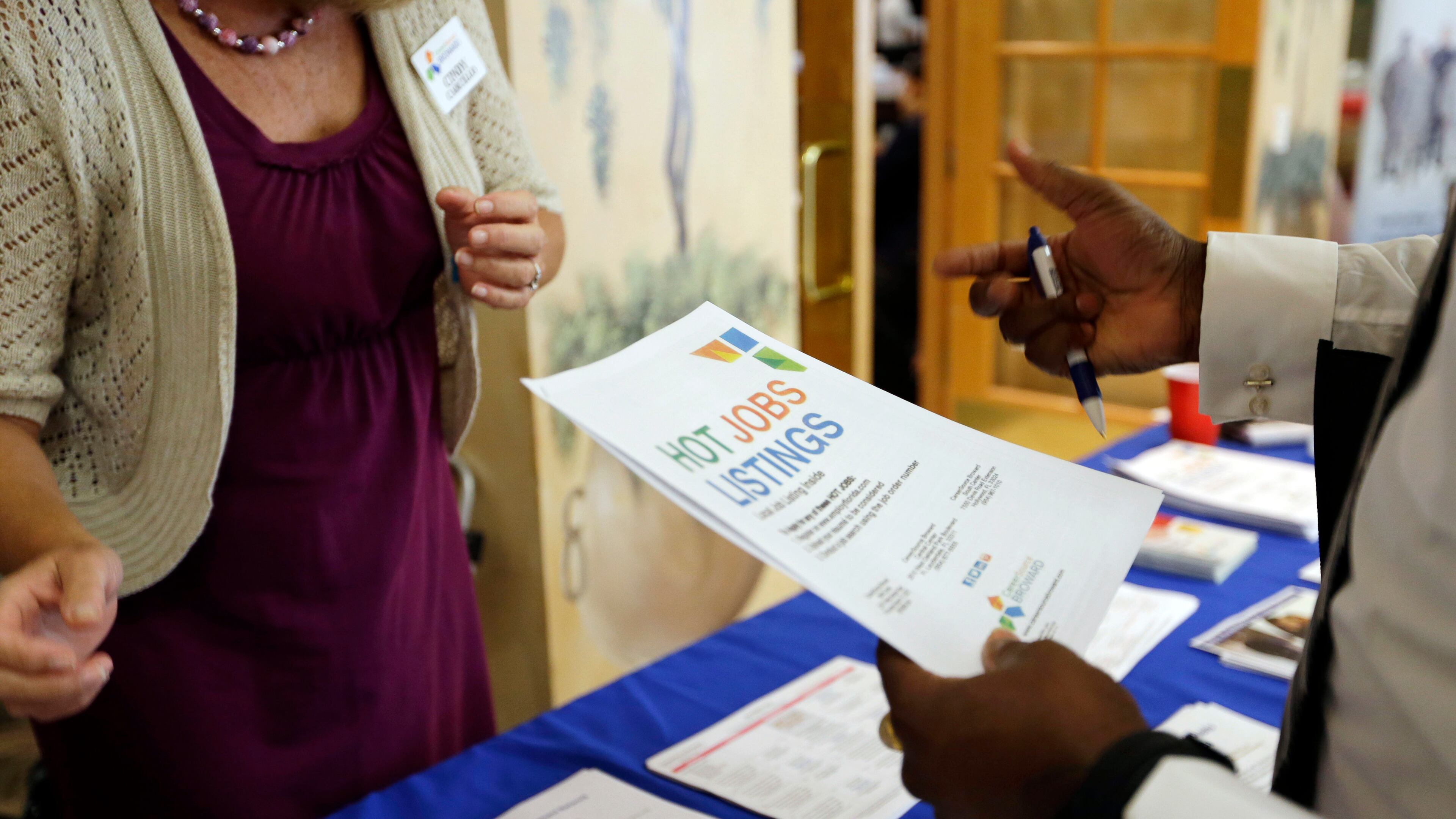 In this 2015 file photo, employment opportunities are discussed at a job fair for veterans, in Pembroke Pines, Florida.