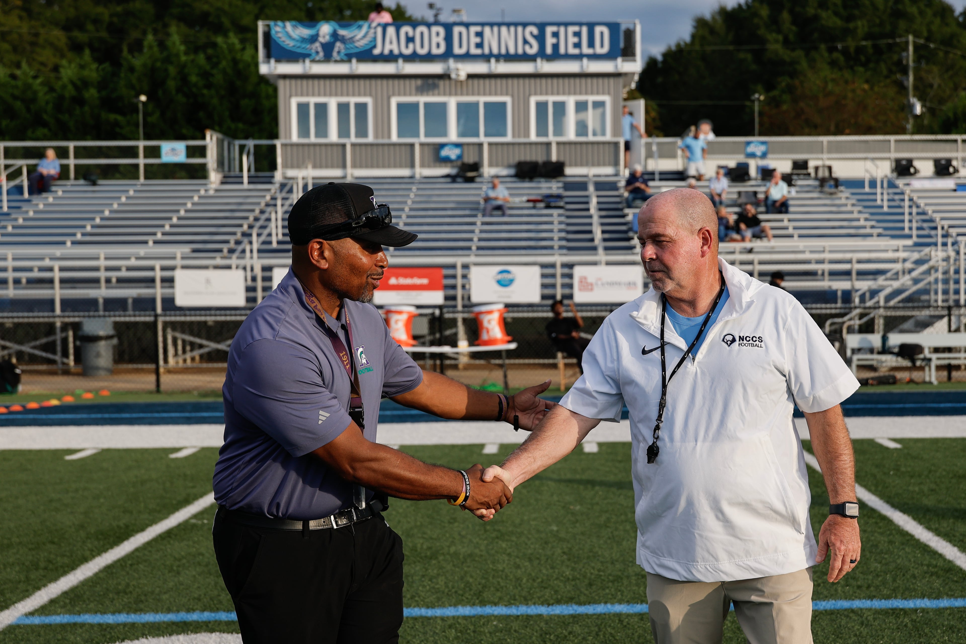 KIPP Atlanta coach Corey Jarvis (left) meets with North Cobb Christian coach PJ Hughes before their game on Friday, Oct. 2, 2026, in Kennesaw. (Erik S. Lesser for the AJC)