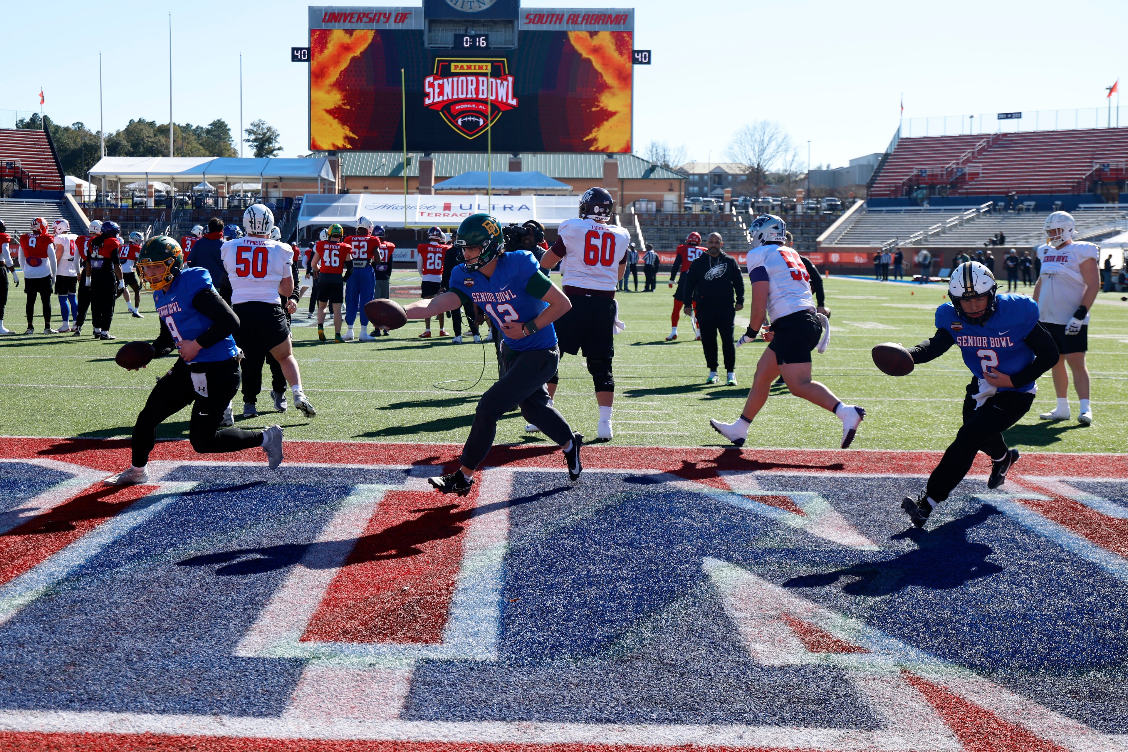 Quarterbacks Cole Payton (9, North Dakota State), Sawyer Robertson (12, Baylor) and Diego Pavia (2, Vanderbilt) run through some Senior Bowl drills on Tuesday.