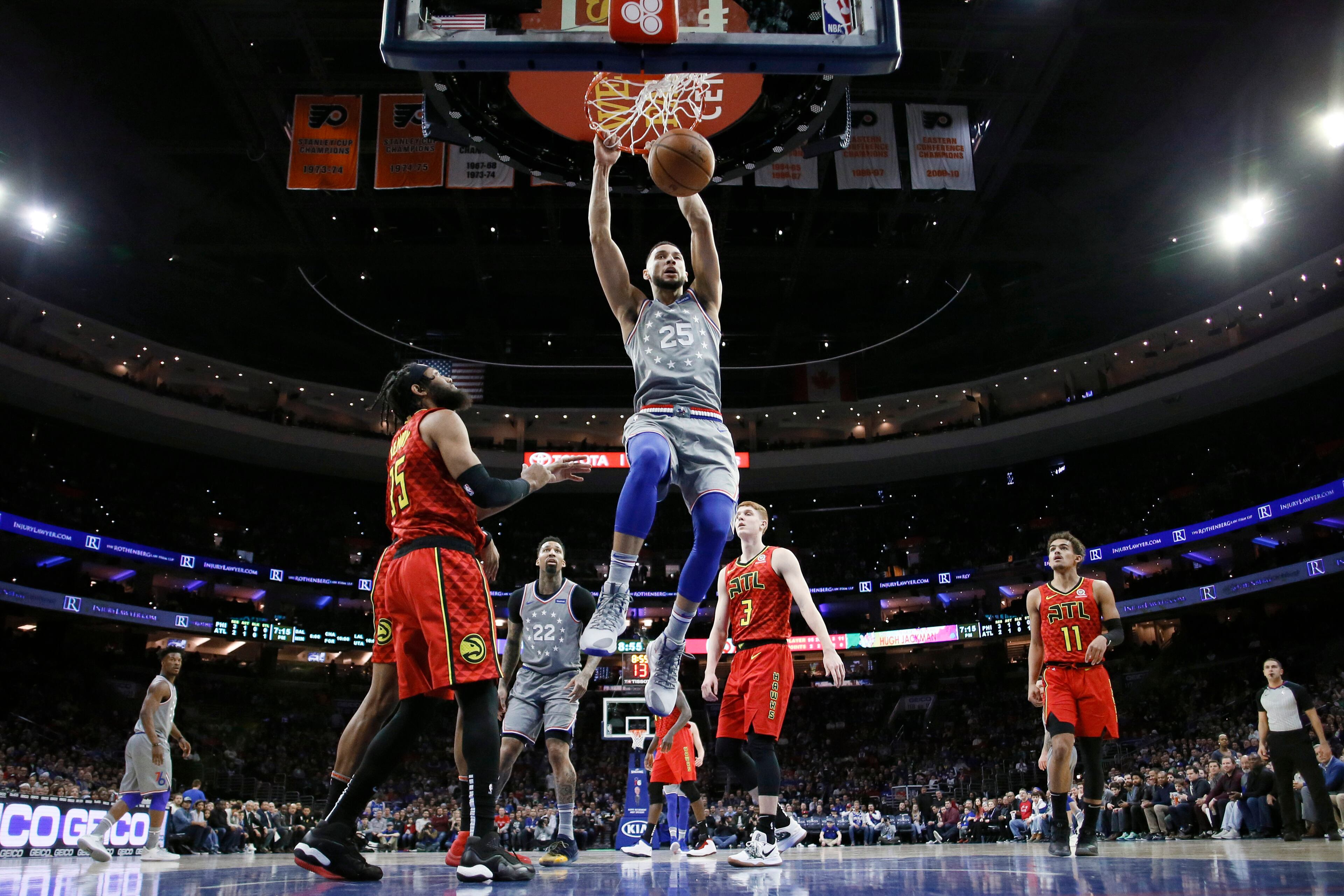 Philadelphia 76ers' Ben Simmons (25) dunks next to Atlanta Hawks' DeAndre' Bembry (95) during the first half of an NBA basketball game Friday, Jan. 11, 2019, in Philadelphia. (AP Photo/Matt Slocum)