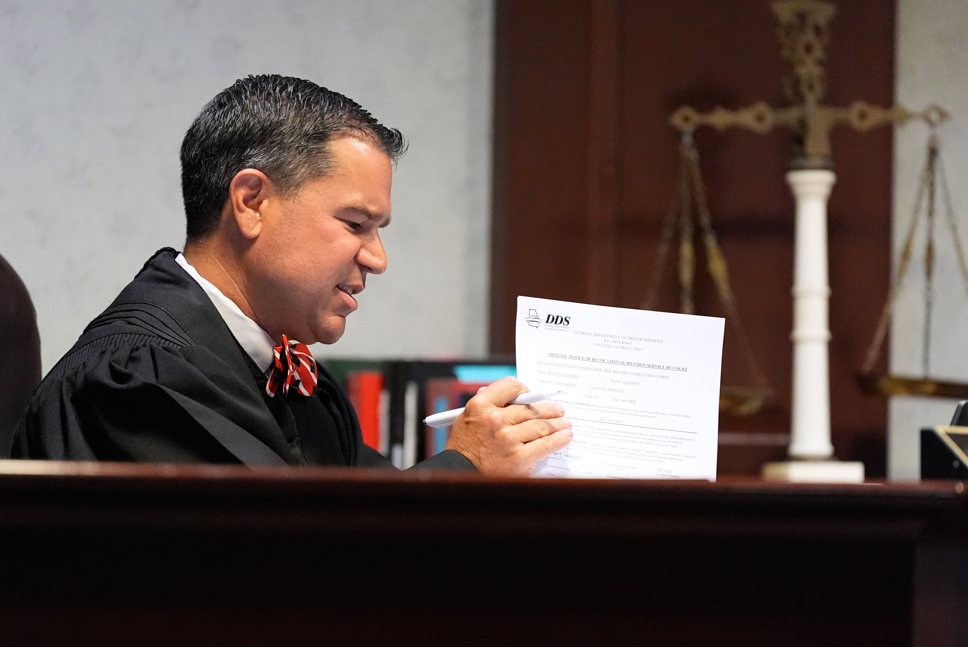 Judge Jason B. Thompson holds up a piece of paper during comedian and actor Tiffany Haddish’s court appearance via Zoom Tuesday, Aug. 11, 2026, in Fayetteville, Ga. (Brynn Anderson/AP)