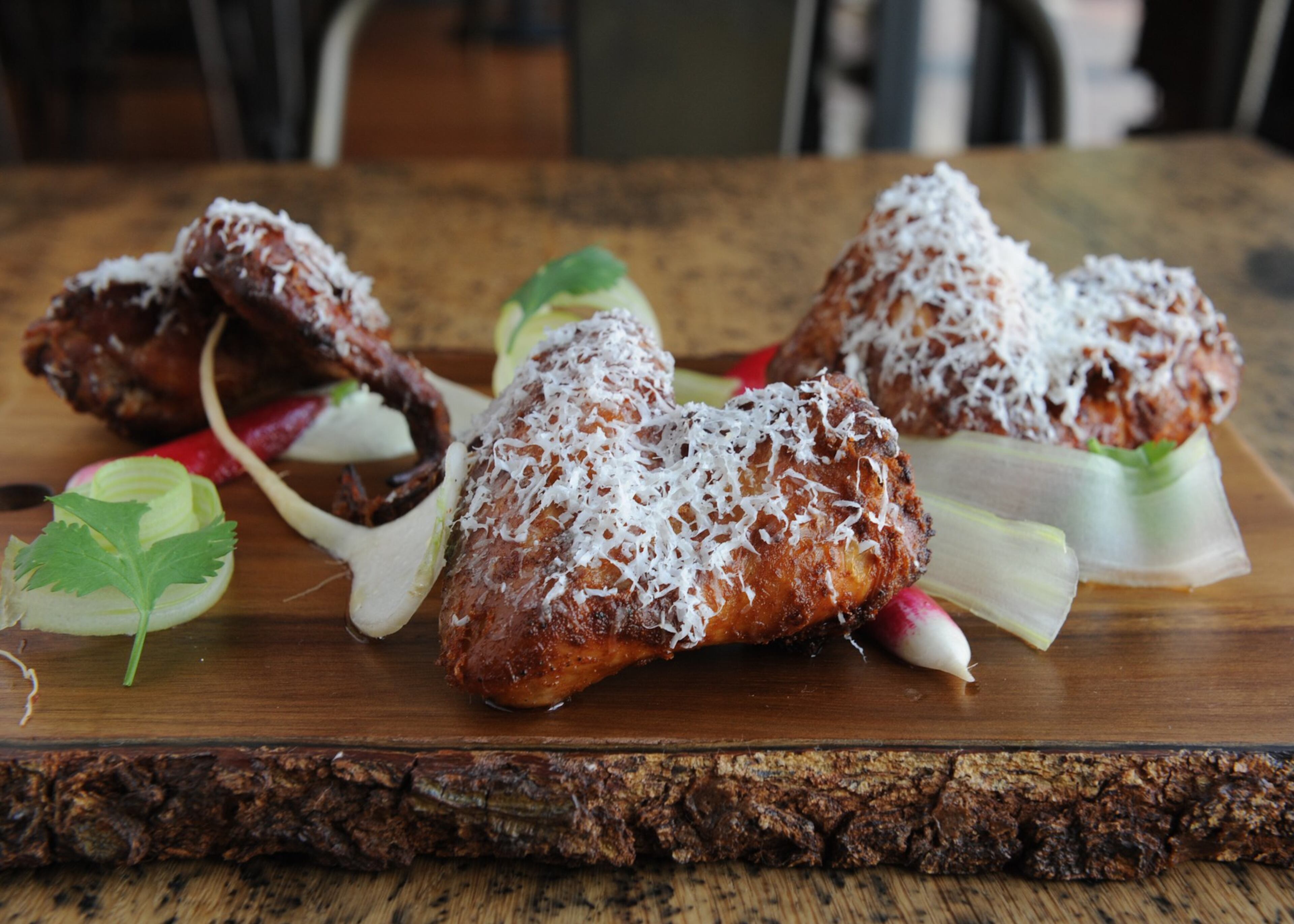 Chef Justin Balmes’ dry-rubbed and smoked wings with avocado/jalapeno/garlic dressing, baby turnips, radish, manchego. (BECKY STEIN PHOTOGRAPHY)