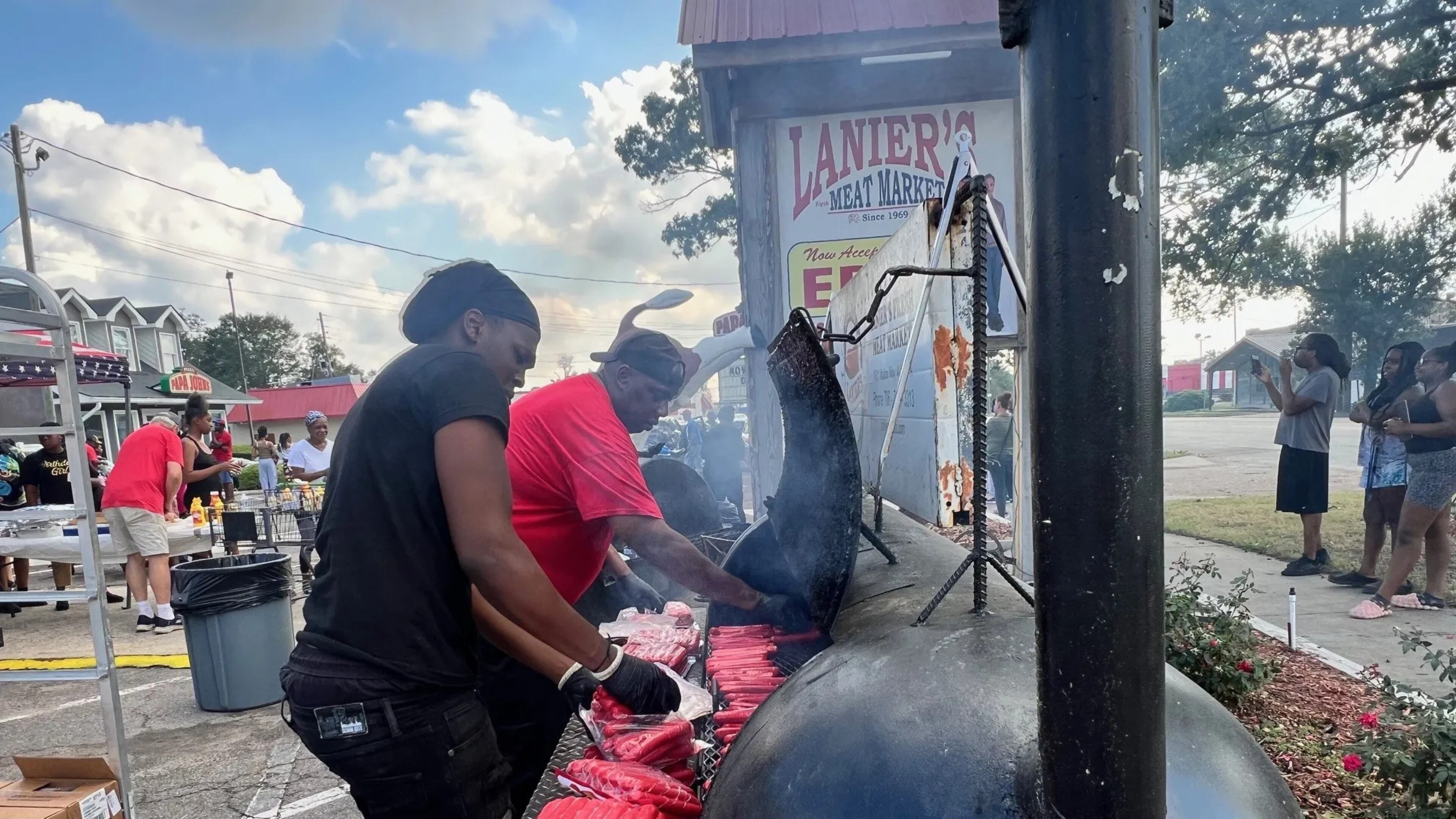 Employees at Lanier's Fresh Meat Market grilled hotdogs for local residents on Monday, September 30, 2024. (Photo Courtesy of Charmain Z. Brackett/Augusta Good News)