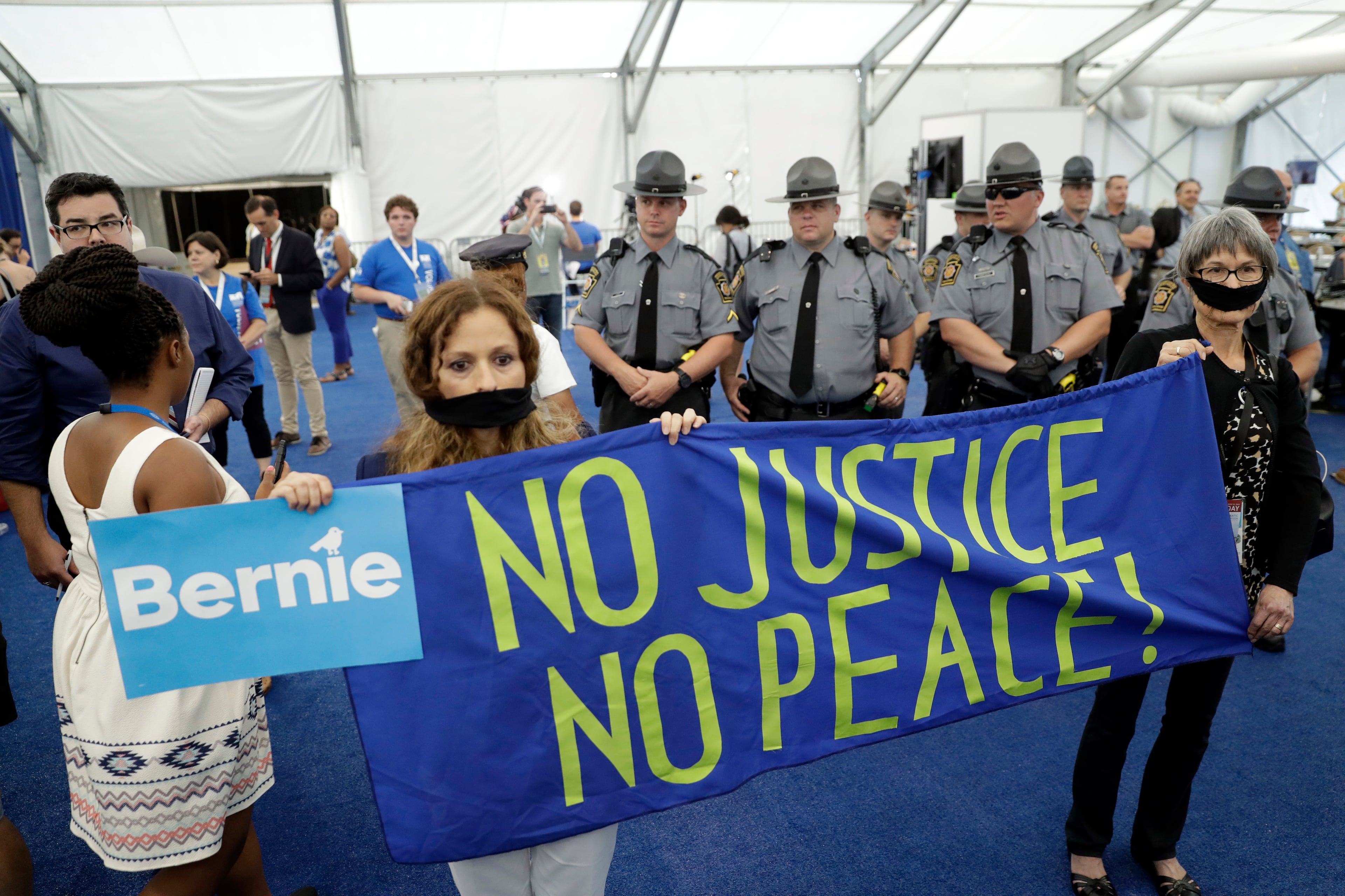 Delegates protest in the media filing center as they walk out of the convention floor during the second day session of the Democratic National Convention in Philadelphia, Tuesday, July 26, 2016. (AP Photo/Matt Rourke)