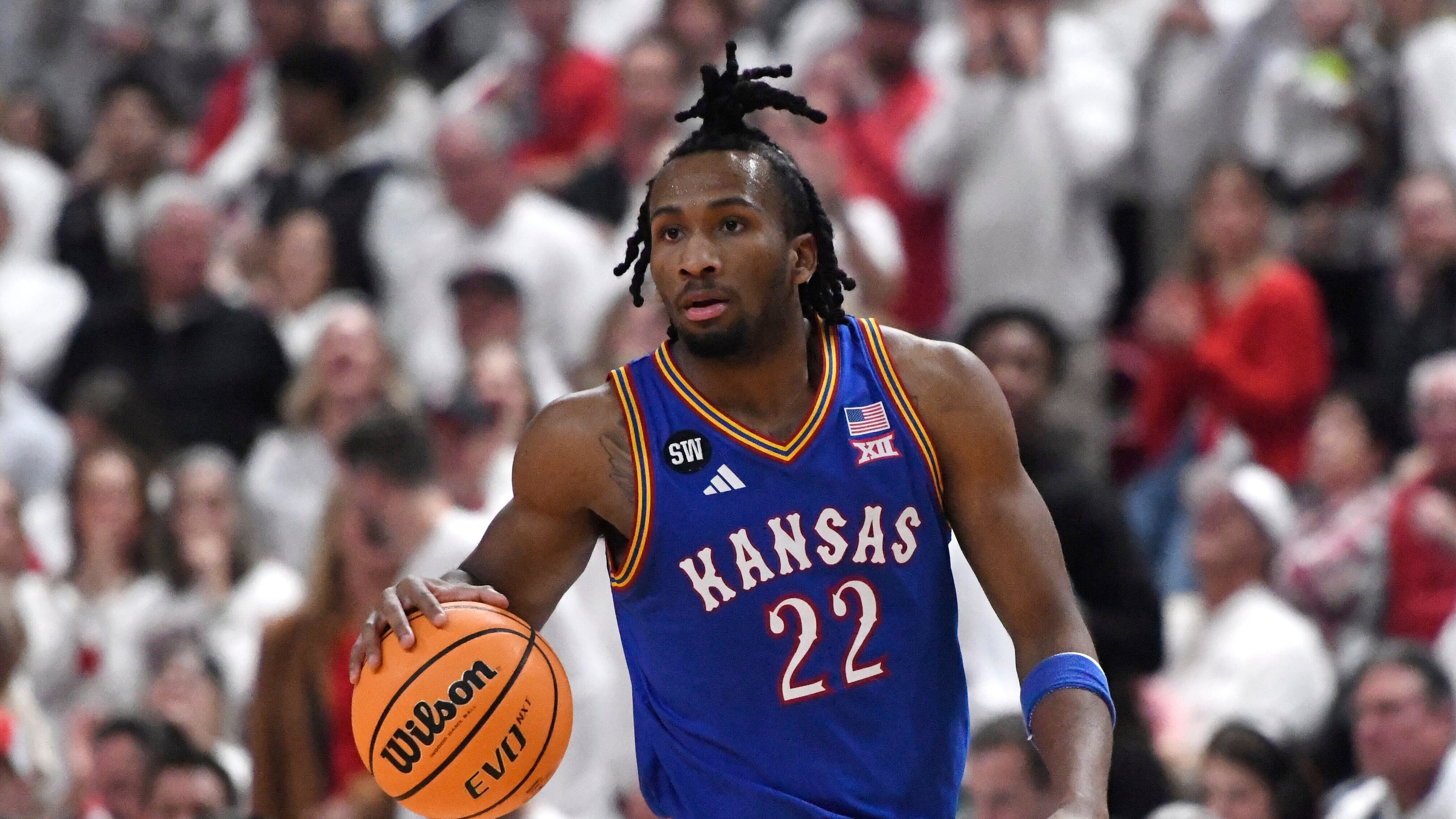 Kansas guard Darryn Peterson dribbles during the second half of an NCAA college basketball game against Texas Tech, Monday, Feb. 2, 2026, in Lubbock, Texas. (AP Photo/Annie Rice)