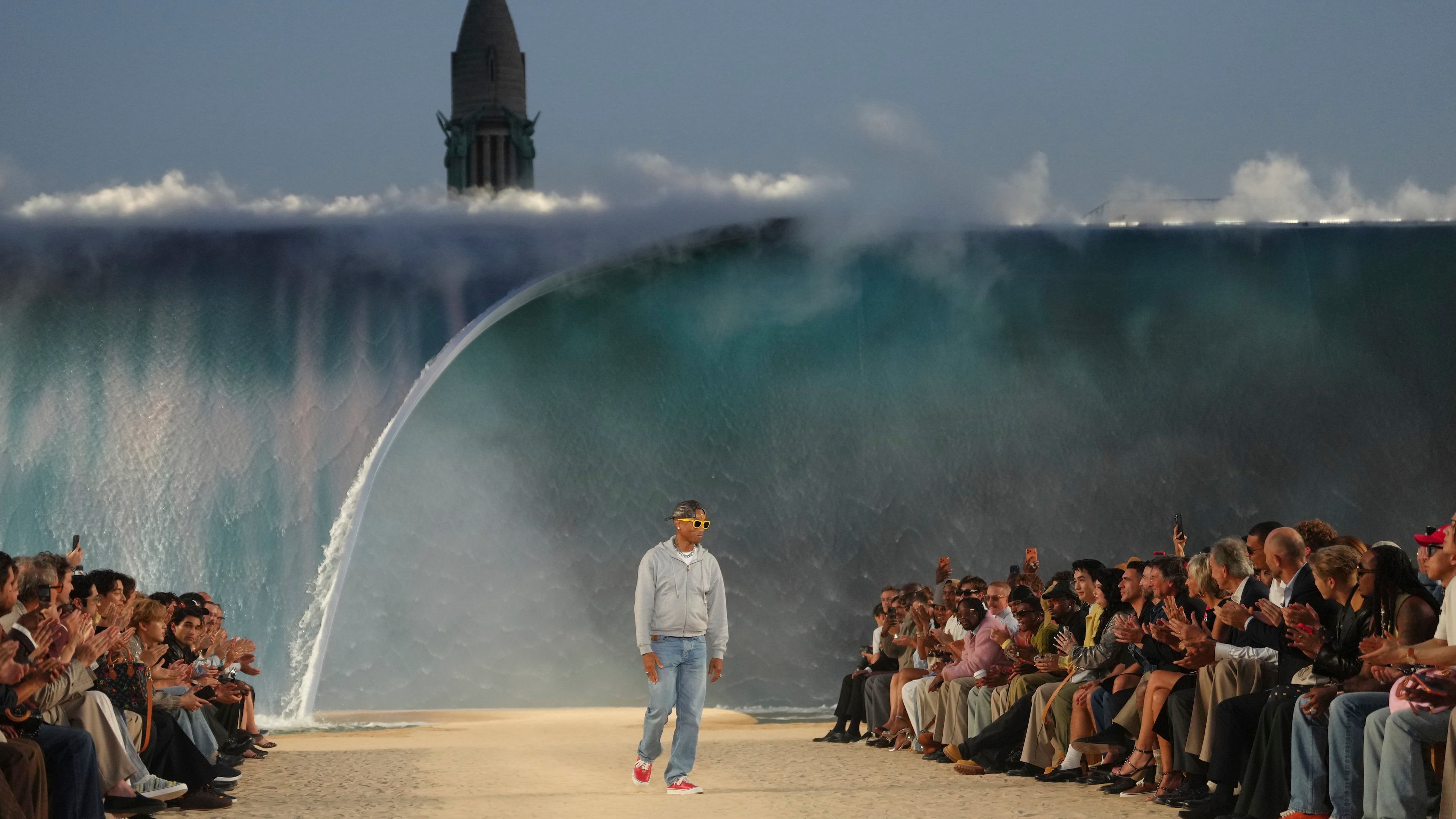 Designer Pharrell Williams accepts applause afte the Louis Vuitton men's Spring Summer 2027 collection presented in Paris, France, Tuesday, June 23, 2026. (AP Photo/Aurelien Morissard)