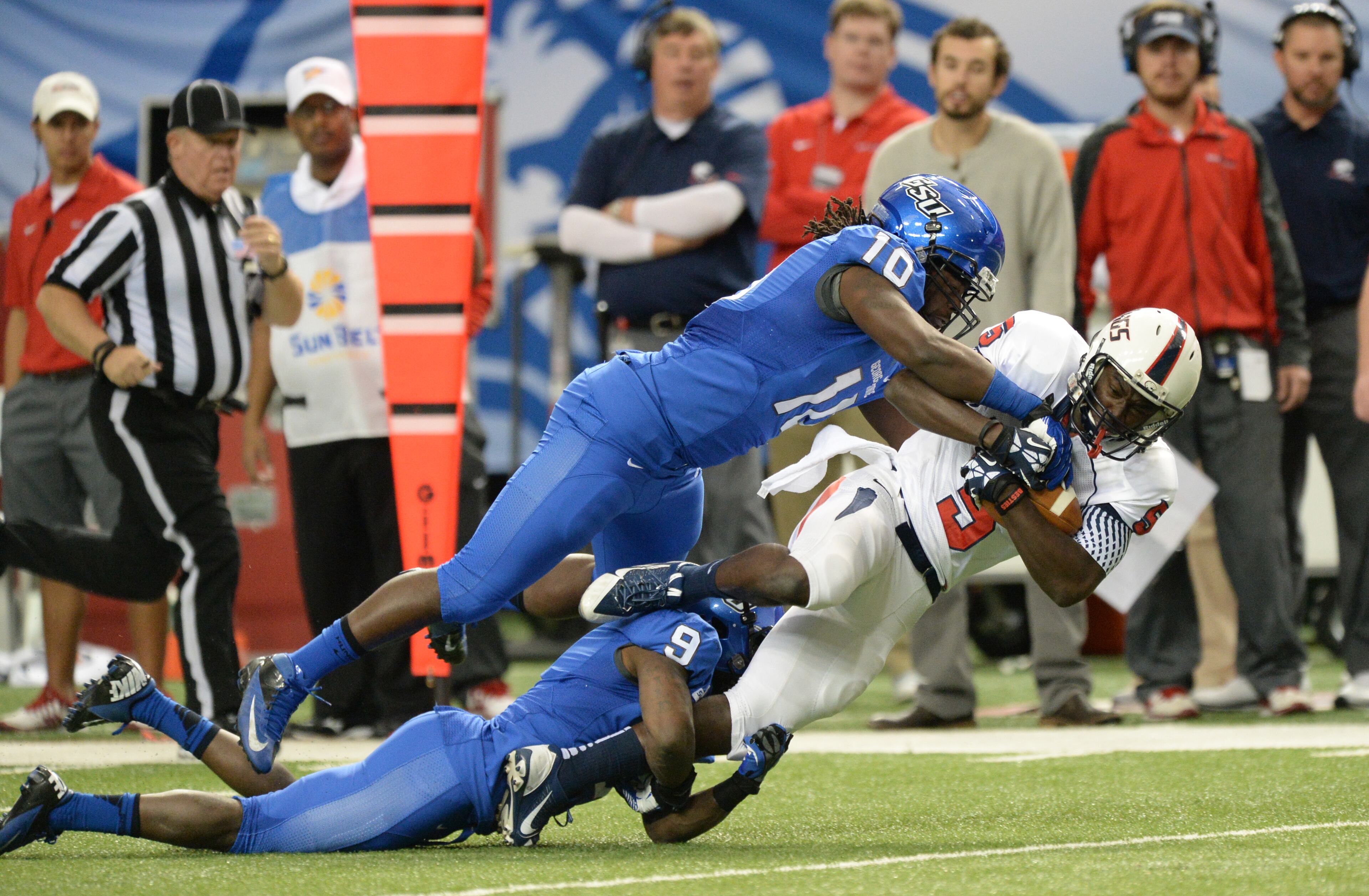 South Alabama Jaguars wide receiver Bryant Lavender (5) is brought down by Georgia State Panthers linebacker Robert Ferguson (10) and Georgia State Panthers cornerback Brent McClendon (9) in the first half on Saturday, November 30, 2013, at the Georgia Dome.