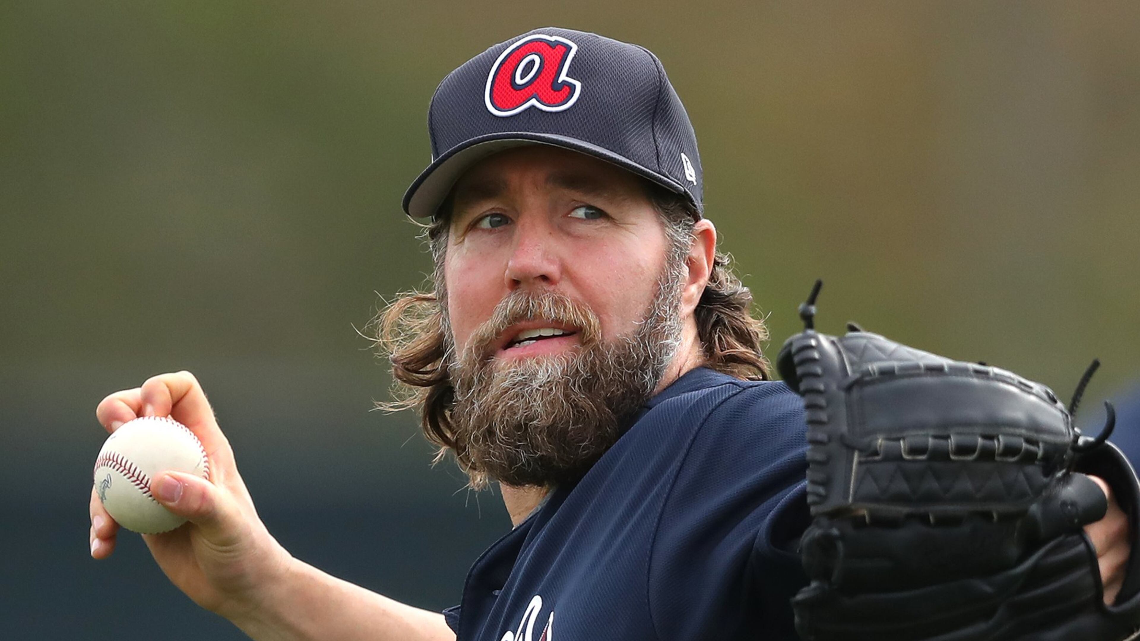 Veteran knuckleballer R.A. Dickey threw off a mound Wednesday in the first workout for Braves pitchers and catchers. (Curtis Compton/ccompton@ajc.com)
