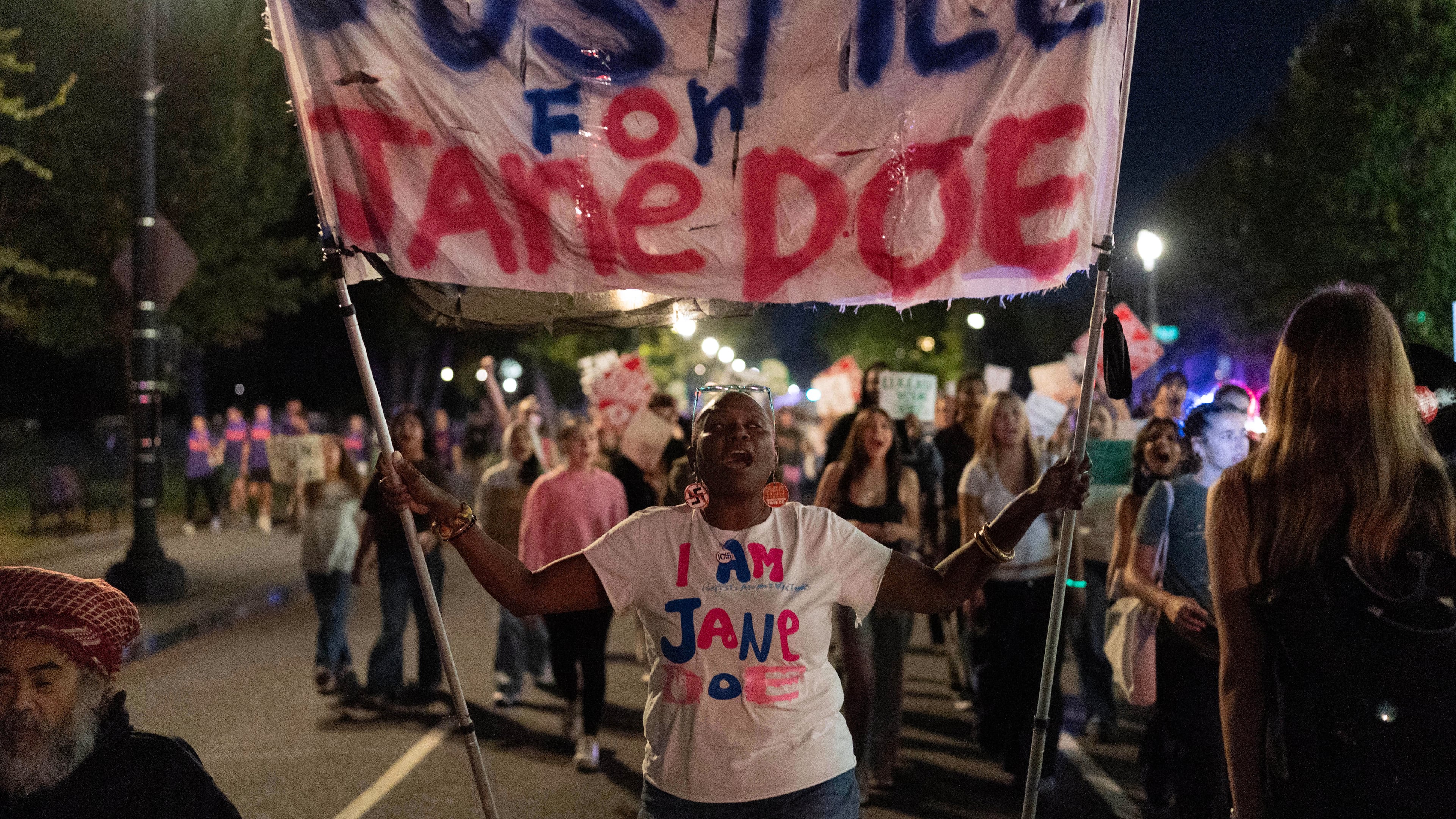 Demonstrators march from the Washington Monument to the White House during a "Stop Sexual Violence" protest in Washington, Thursday, Oct. 8, 2026. (AP Photo/Jose Luis Magana)