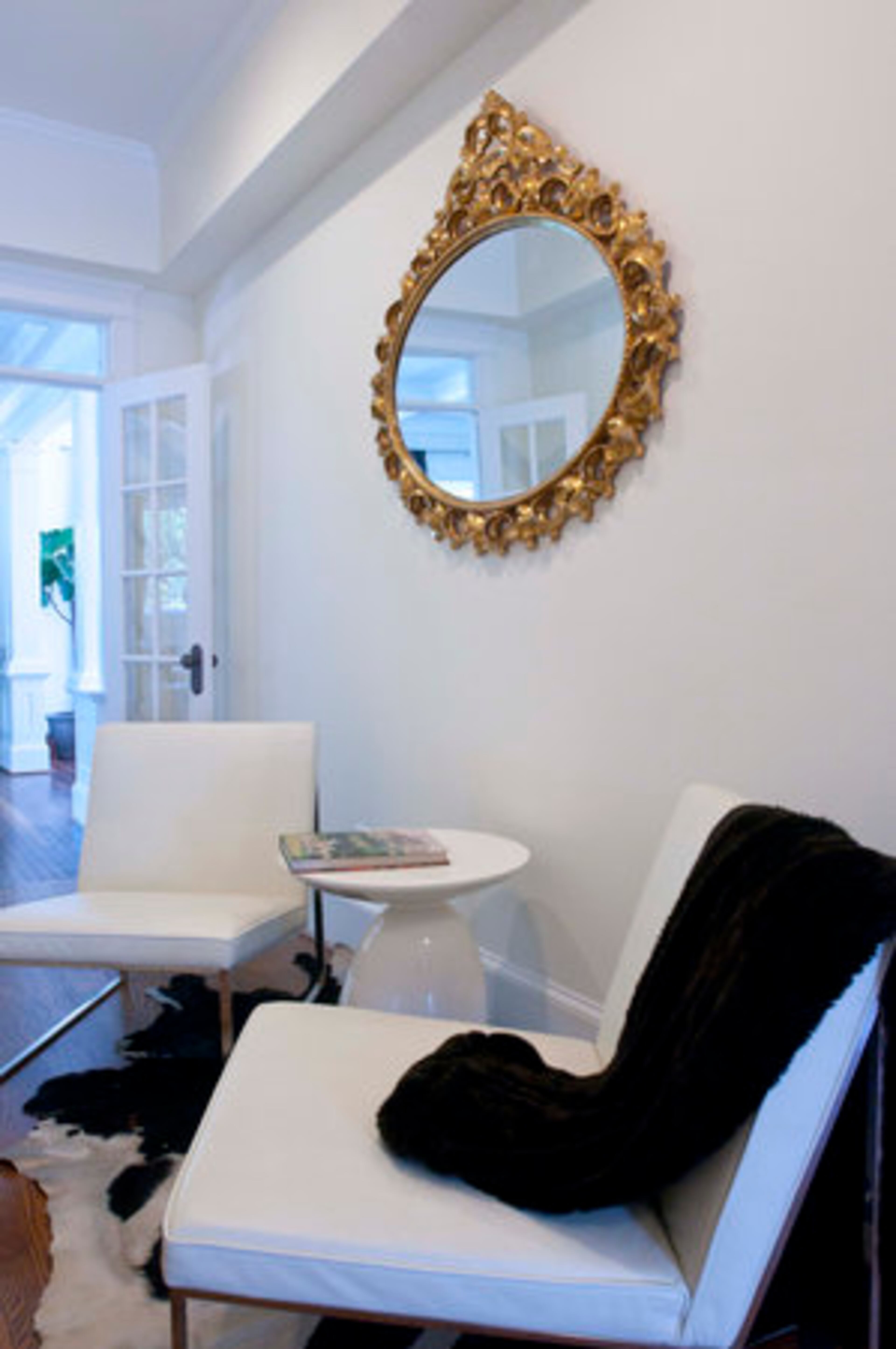 The gold-leaf mirror in the hallway of the home is an heirloom from Alejandra Dunphy's mother.