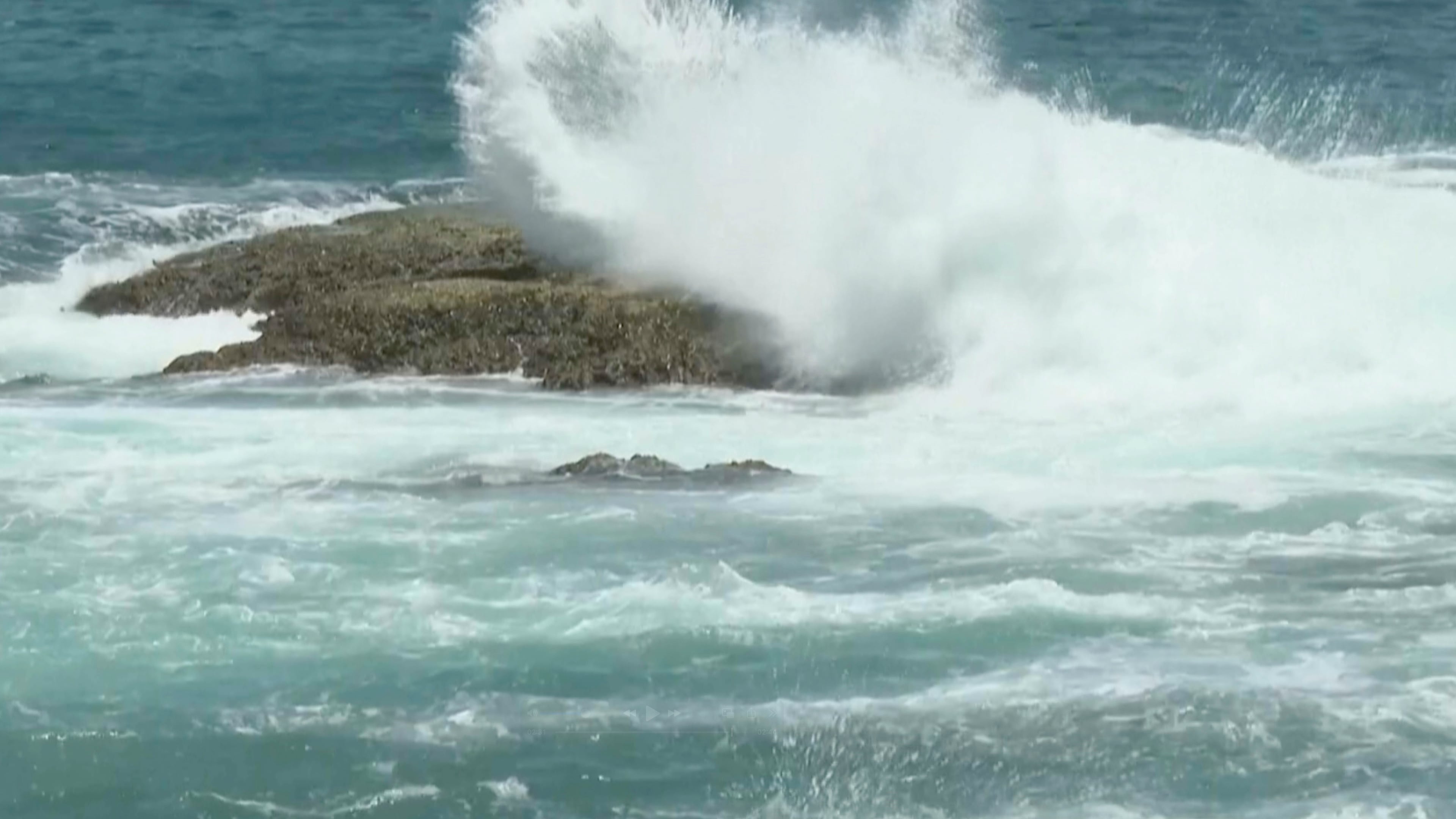 In this image made from video, waves crash on rocks ahead of Typhoon Bavi along the coast of Keelung in northern Taiwan on Thursday, July 9, 2026. (AP Photo/Taijing Wu)