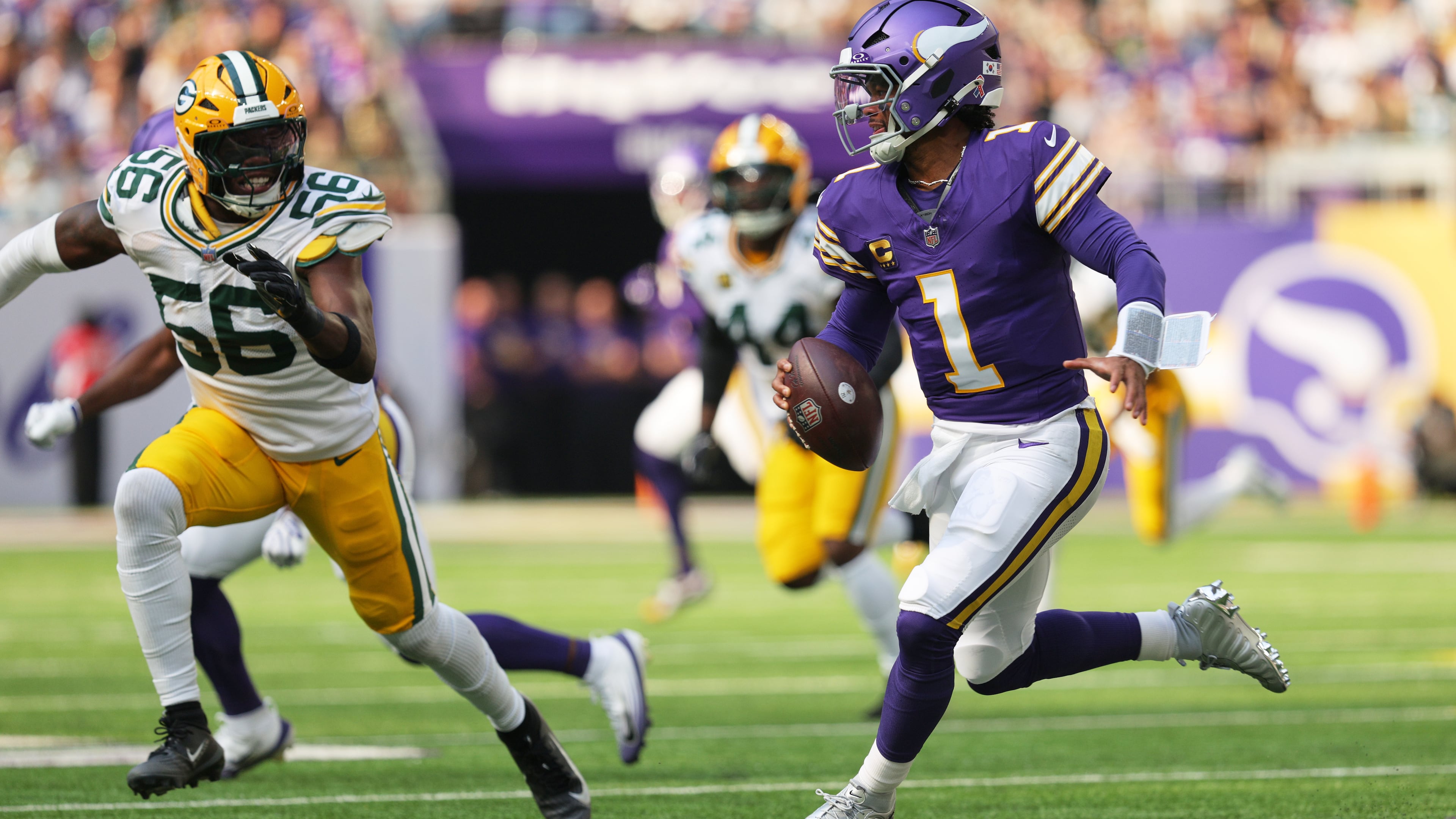 Minnesota Vikings quarterback Kyler Murray (1) scrambles under pressure from Green Bay Packers linebacker Edgerrin Cooper (56) during the first half of an NFL football game, Sunday, Sept. 13, 2026, in Minneapolis, Minn. (AP Photo/Bailey Hillesheim)