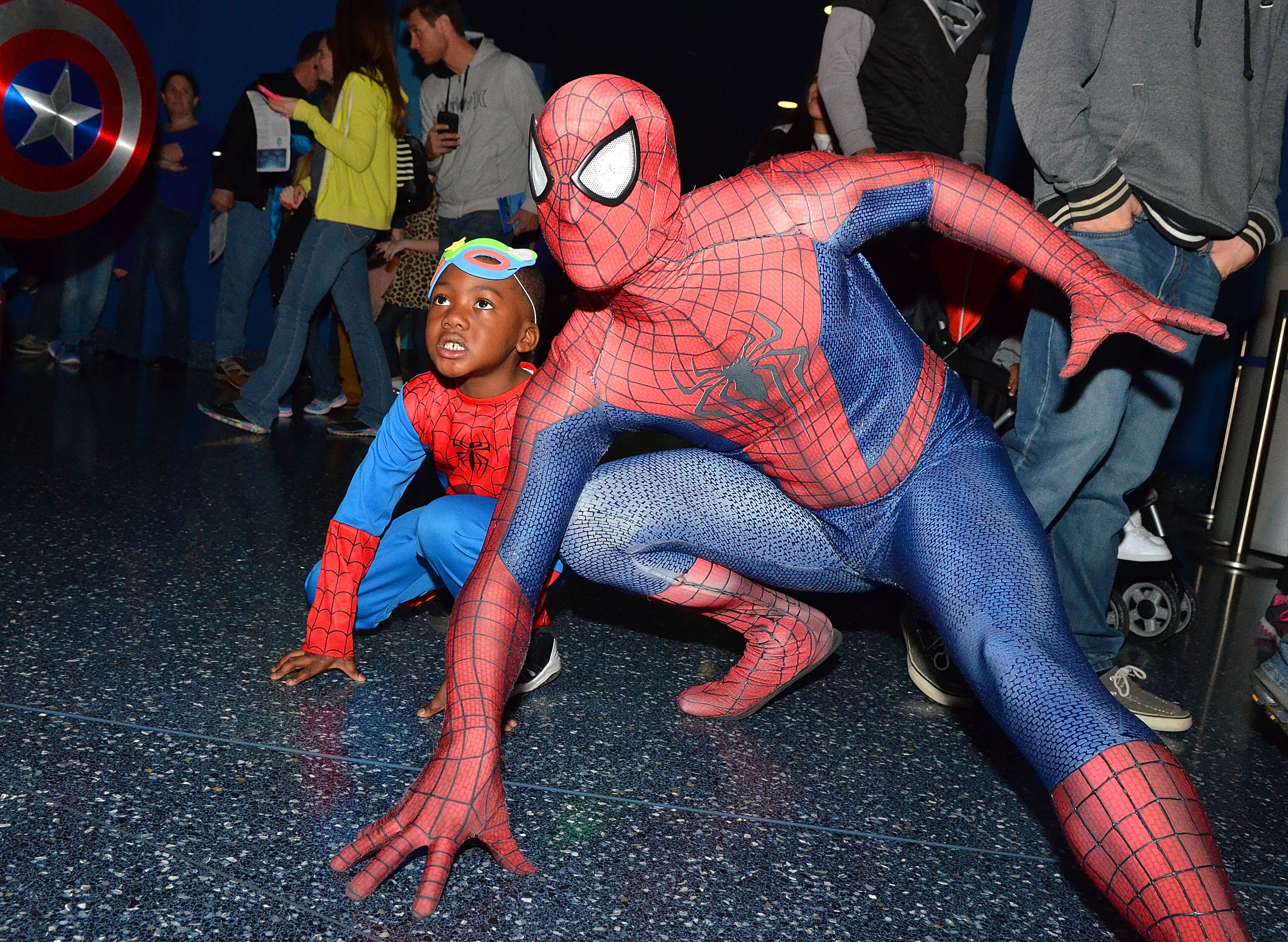 Atlanta, Georgia: Keilyn Biggins (5) takes on a good Spidey action pose with Spider-Man Saturday afternoon at Super Hero Day at the Georgia Aquarium. Become a superhero for the ocean at Superhero Day at the Georgia Aquarium, Saturday March 7, 2015, where kids 12 and under who come dressed as a superhero received free admission with each paying adult. The event included special activities held in the atrium of the Aquarium including Make-Your-Own Superhero Mask, Superhero Academy, Games, Photo Stations and Superhero appaearances. (Chris Hunt/Special)