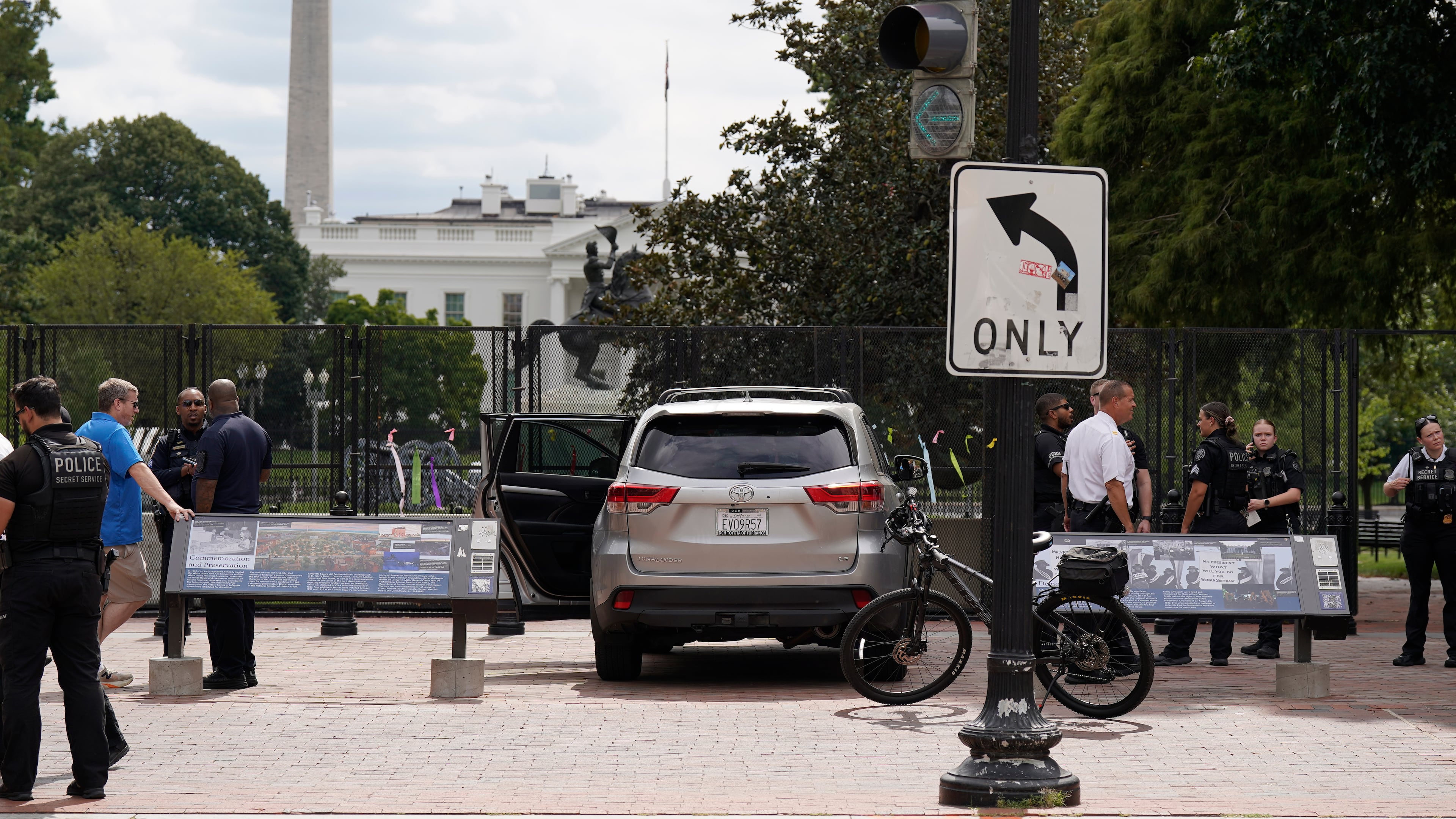 U.S. Secret Service Police stand near a car that sits parked on a sidewalk near the White House after the driver was arrested, Saturday, Sept. 19, 2026, in Washington. (AP Photo/Jose Luis Magana)