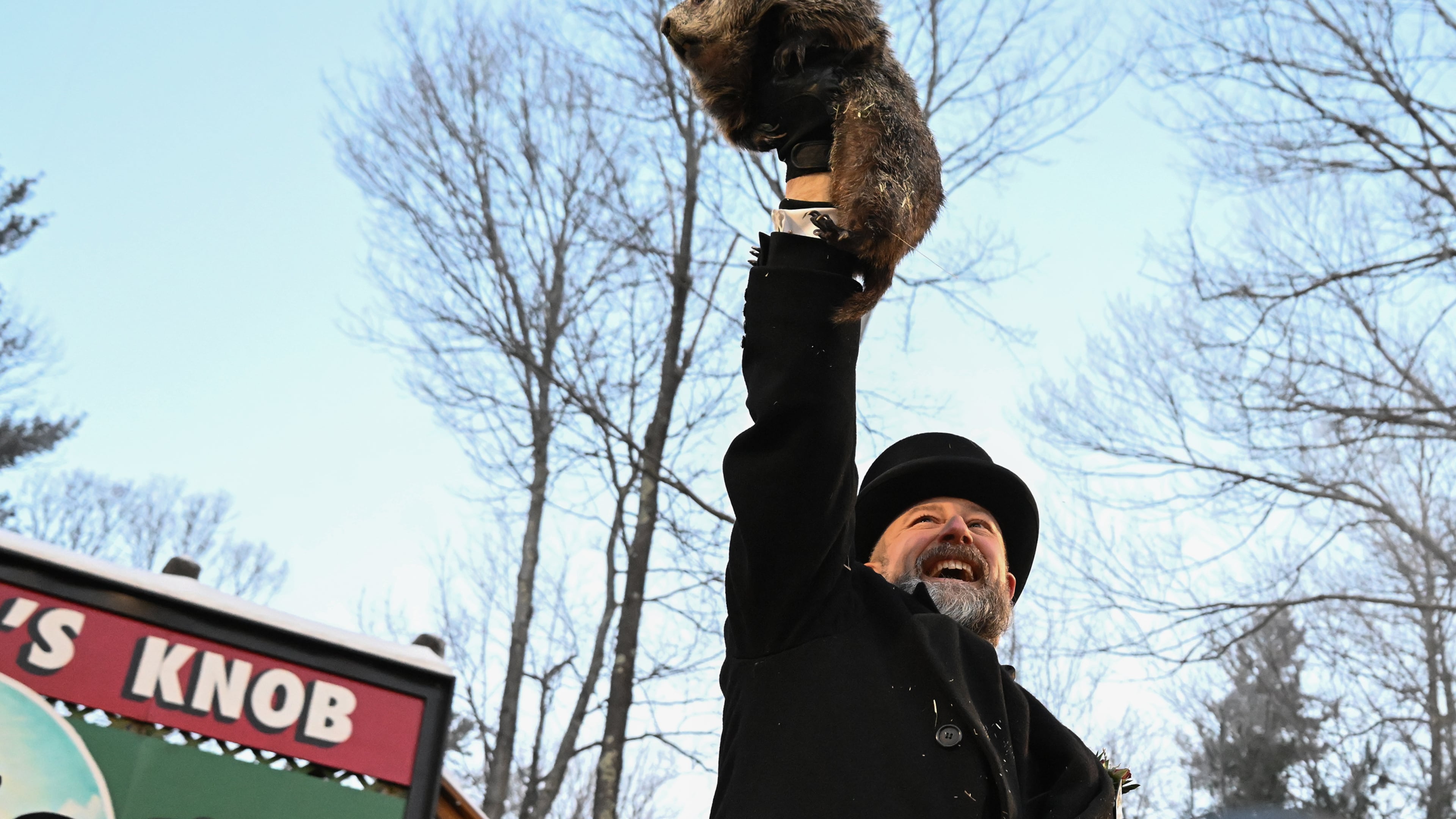 Groundhog Club handler A.J. Dereume holds Punxsutawney Phil, the weather prognosticating groundhog, during the 140th celebration of Groundhog Day on Gobbler's Knob in Punxsutawney, Pa., Monday, Feb. 2, 2026. Phil's handlers said that the groundhog has forecast six more weeks of winter. (AP Photo/Barry Reeger)