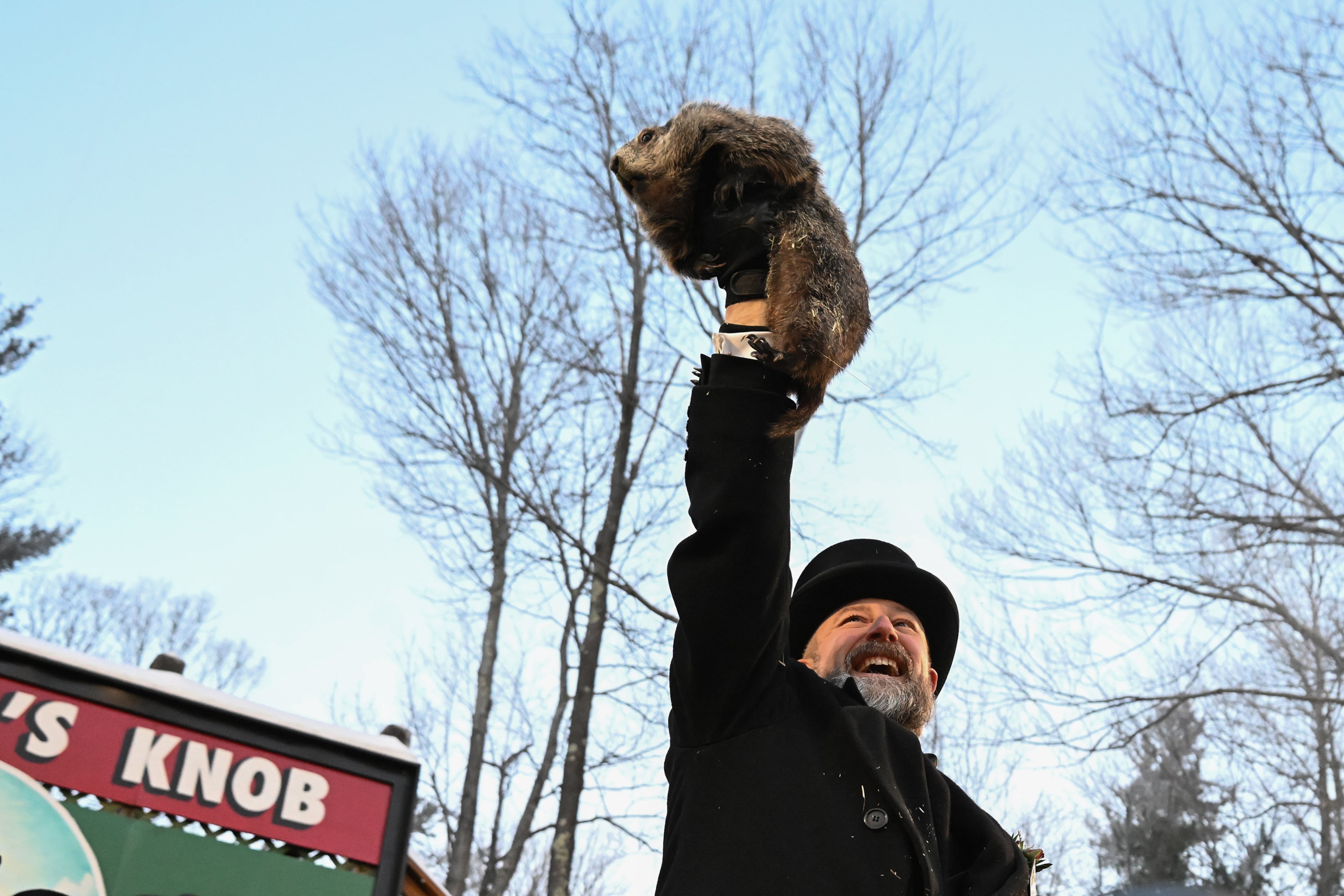 Groundhog Club handler A.J. Dereume holds Punxsutawney Phil, the weather prognosticating groundhog, during the 140th celebration of Groundhog Day on Gobbler's Knob in Pennsylvania on Monday. Phil's handlers said the rodent has forecast six more weeks of winter. (Barry Reeger/AP)