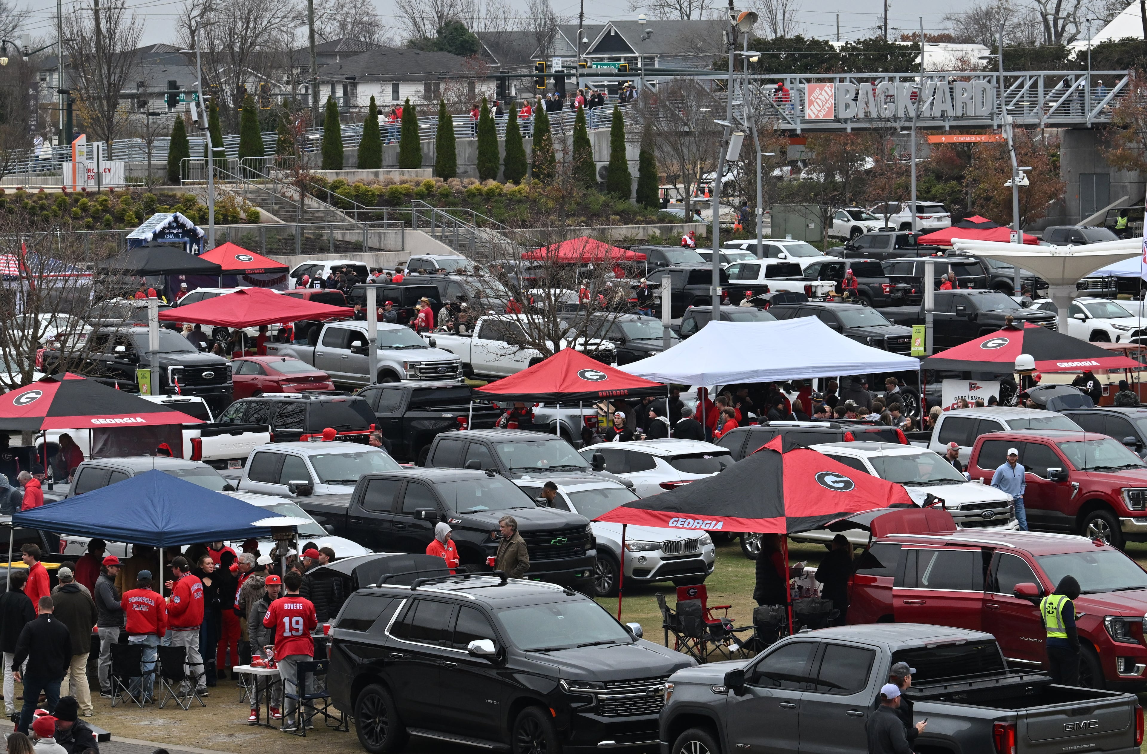 Football fans enjoy tailgating at he Home Depot Backyard ahead of the SEC Championship football game between Georgia and Alabama, Saturday, Dec. 6, 2025 in Atlanta. (Hyosub Shin/AJC)