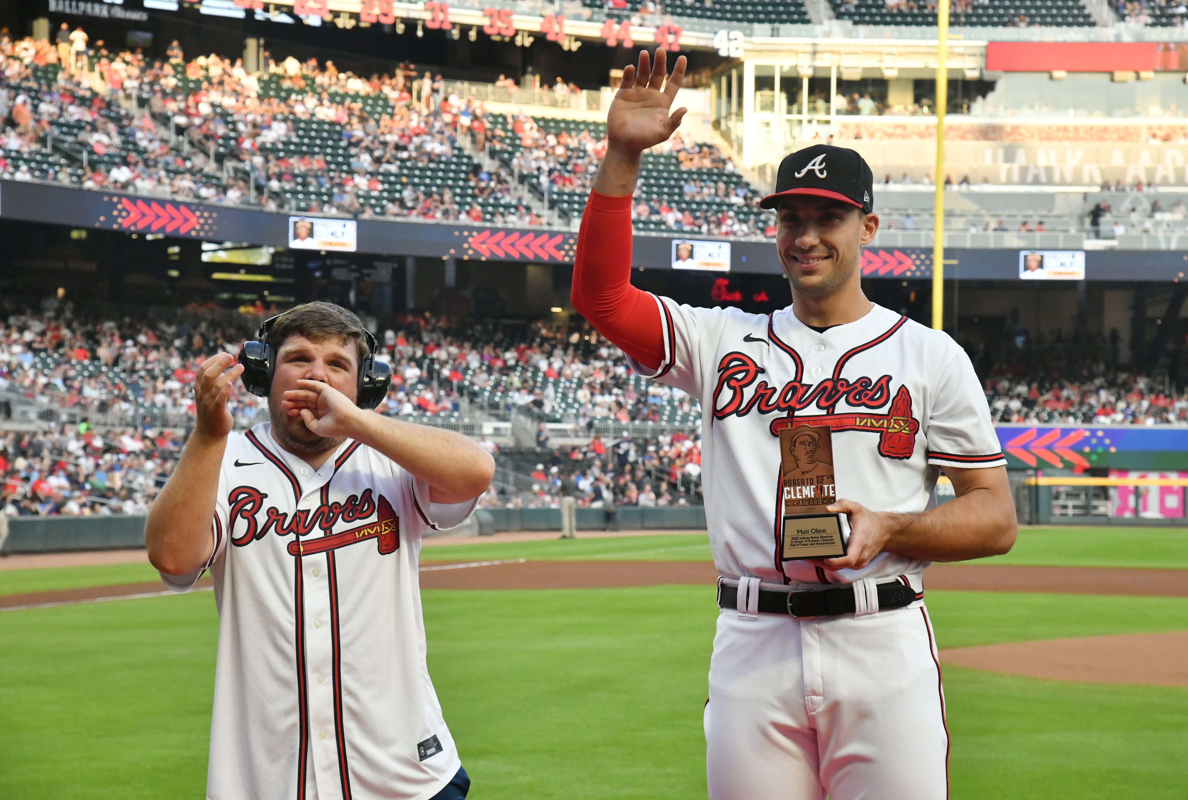 Atlanta Braves first baseman Matt Olson, with friend Reece Blankenship, who has nonverbal autism, is recognized as a Roberto Clemente Award nominee during a pregame ceremony. (Hyosub Shin / Hyosub.Shin@ajc.com)