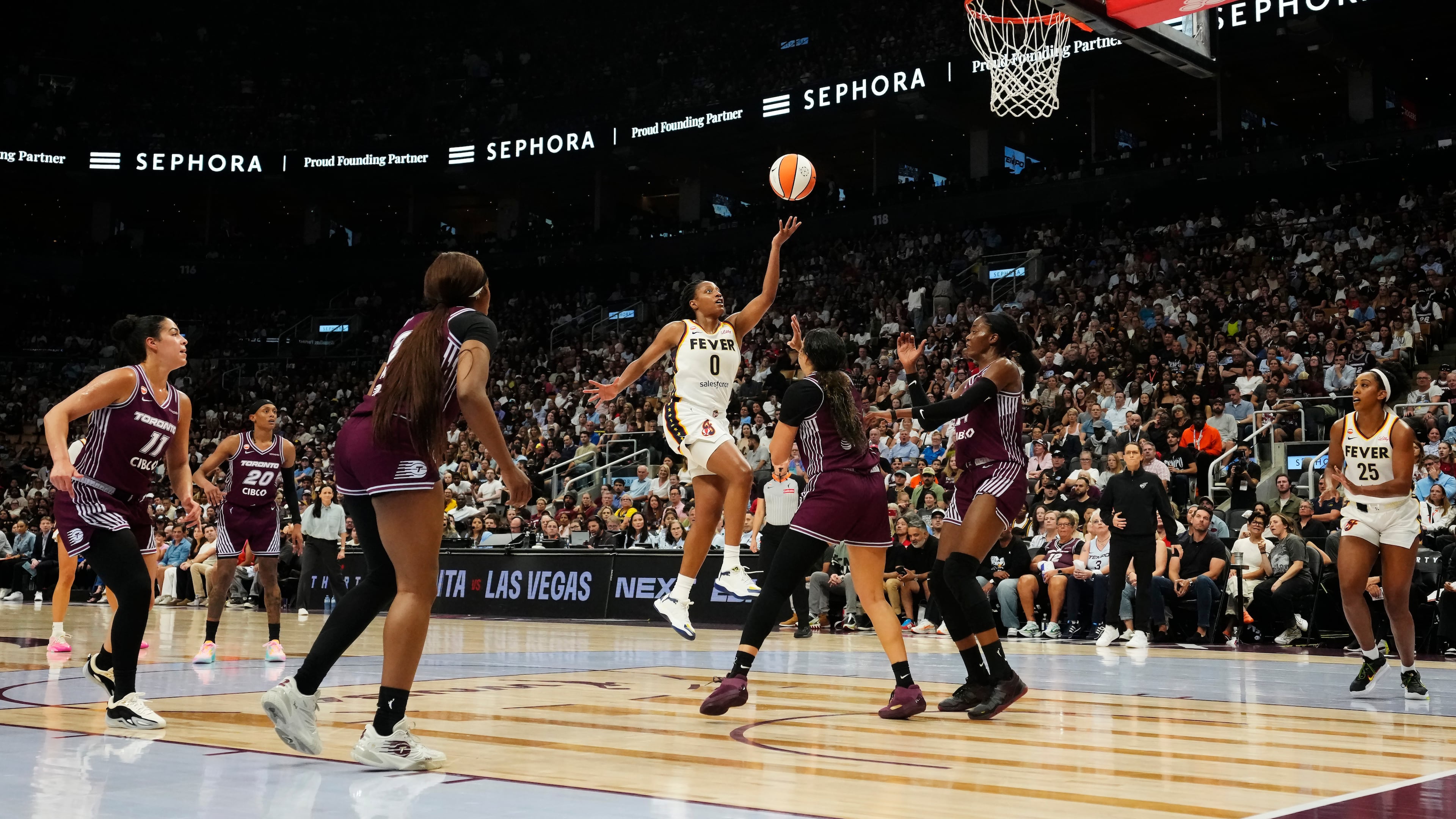 Indiana Fever's Kelsey Mitchell (0) scores past the Toronto Tempo defence during the first half of a WNBA basketball game in Toronto on Tuesday, Aug. 18, 2026. (Chris Young/The Canadian Press via AP)