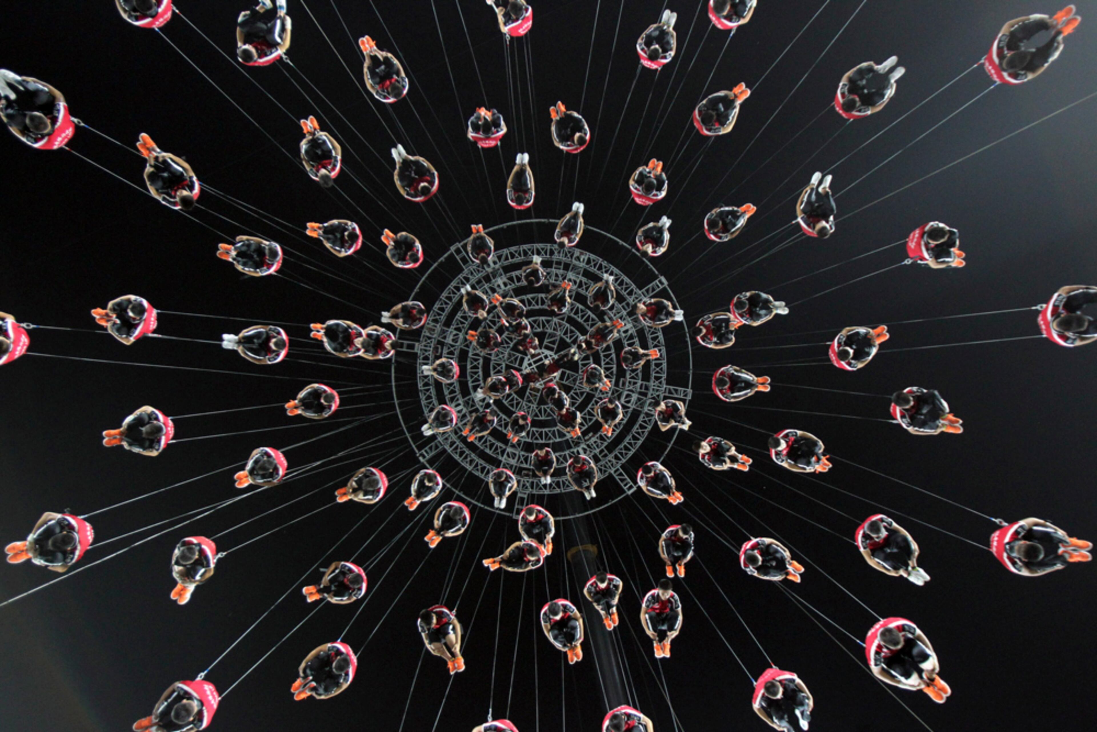 WIRED UP--In this photo taken Thursday, Aug. 14, 2014, performers tied to wires rehearse for the opening ceremony of the 2014 Nanjing Youth Olympic Games which opens Aug. 16, 2014 in Nanjing in east China's Jiangsu province. (AP Photo)