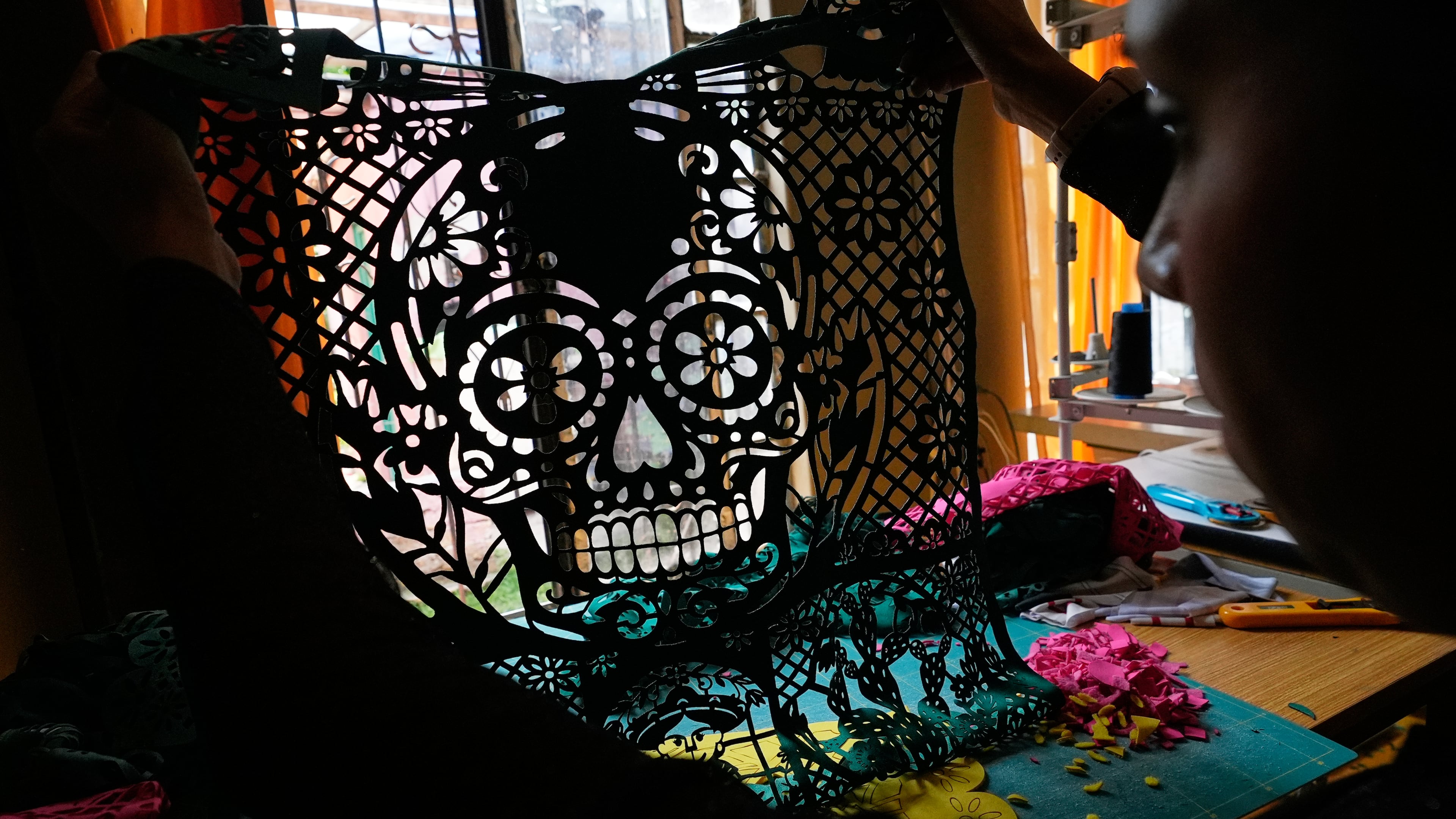 Cande Martinez prepares soccer jerseys, inspired by papel picado and traditional folk art, from the brand Mexclart, in Cuautitlán Izcalli, Mexico, Monday, May 25, 2026. (AP Photo/Marco Ugarte)