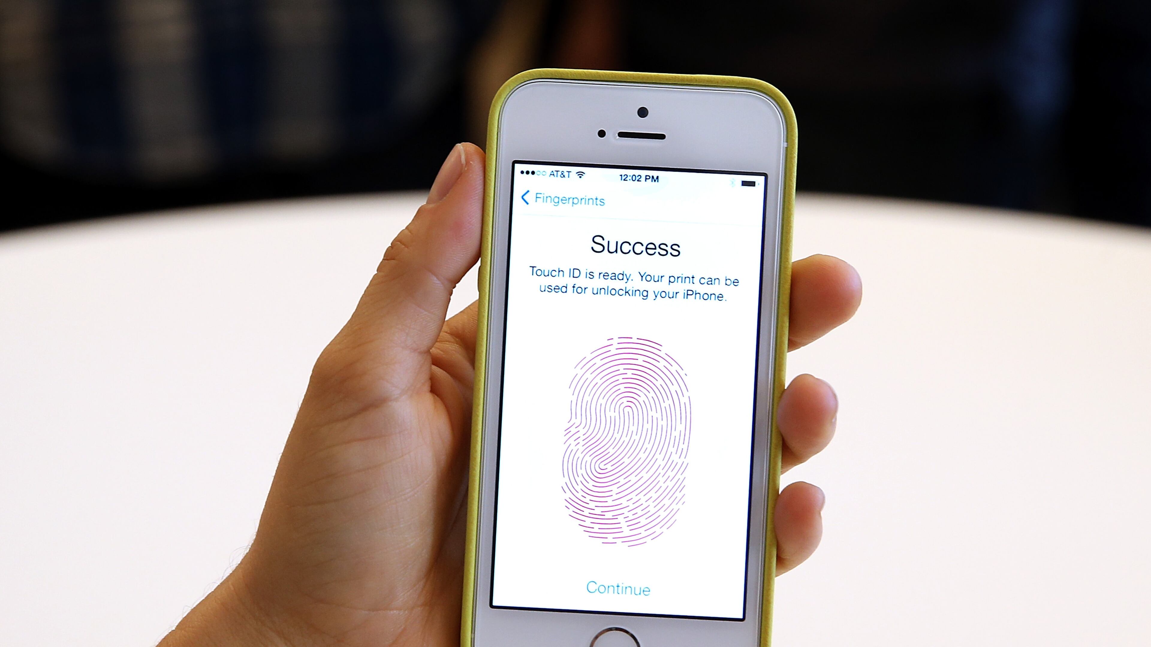 CUPERTINO, CA - SEPTEMBER 10: The new iPhone 5S with fingerprint technology is displayed during an Apple product announcement at the Apple campus on September 10, 2013 in Cupertino, California. The company launched the new iPhone 5C model that will run iOS 7 is made from hard-coated polycarbonate and comes in various colors and the iPhone 5S that features fingerprint recognition security. (Photo by Justin Sullivan/Getty Images)