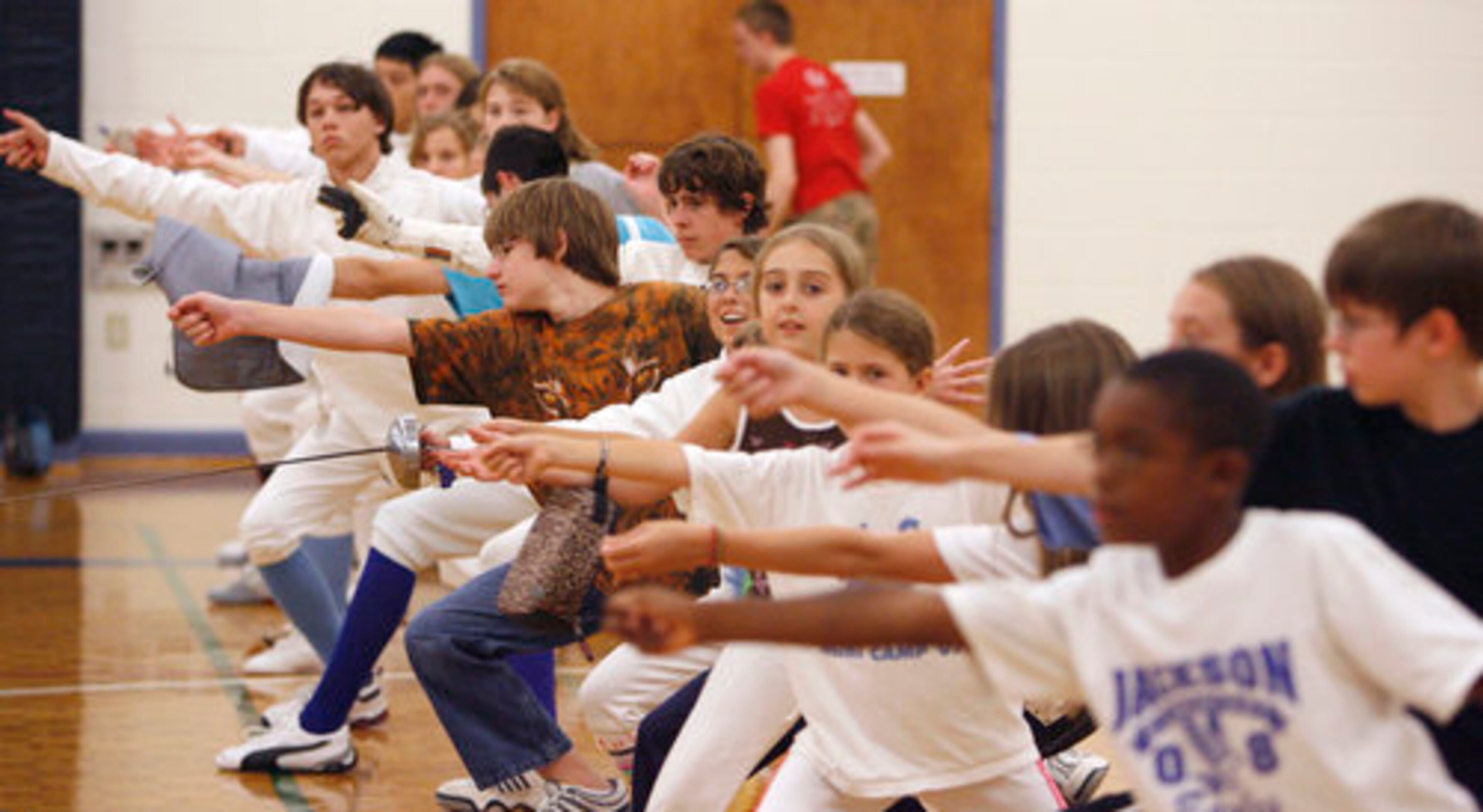 On Guard! Camp members practice some lunges and other practice exercises during the Dunwoody Fencing Club's summer camp this week. Coached by Kathy Vail, campers include members of area high school fencing teams as well as younger beginning fencers.