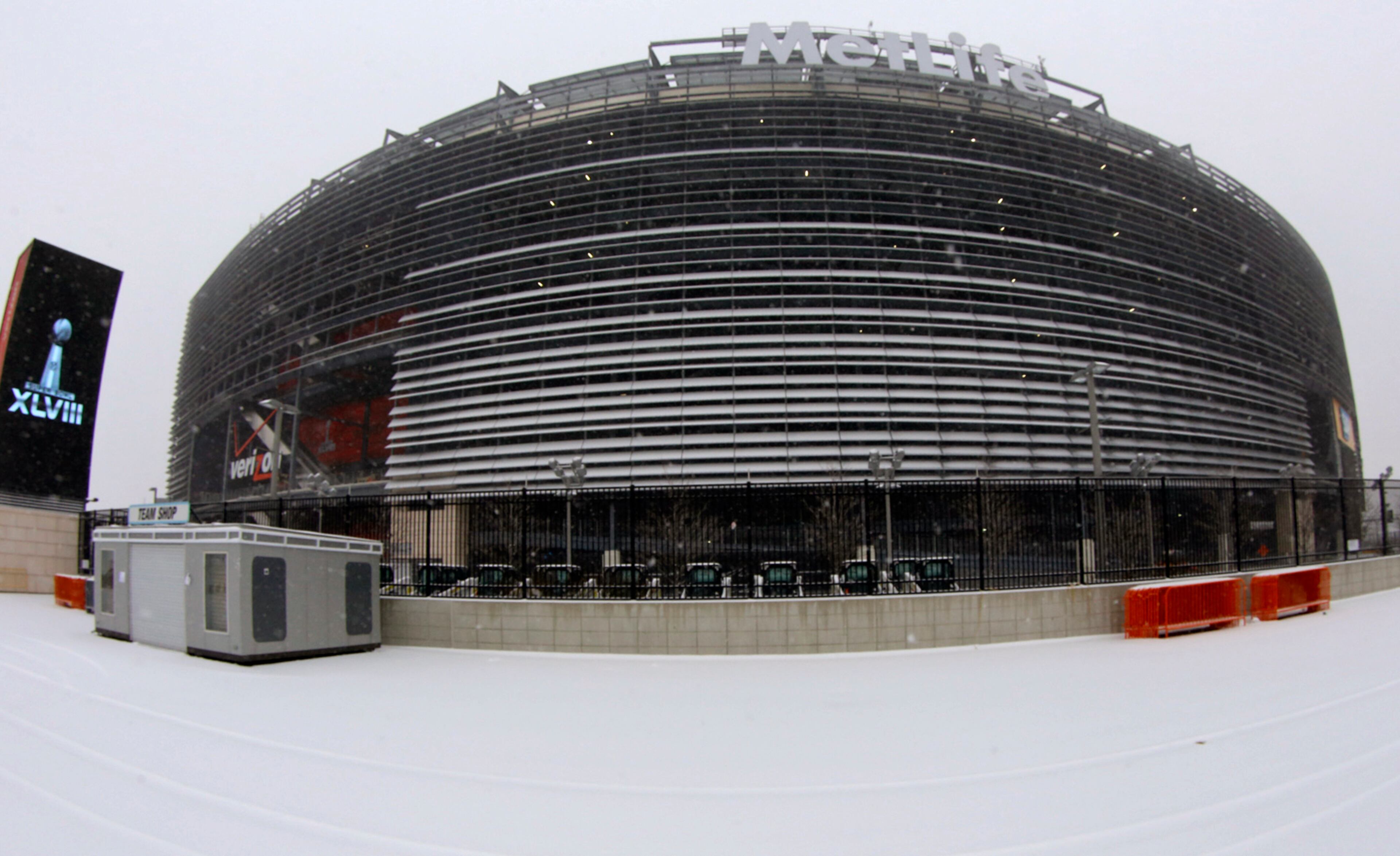 In this image taken with a fisheye lens, a layer of snow covers the ground outside of MetLife, Tuesday, Jan. 21, 2014 in East Rutherford, N.J. The stadium will host NFL football's Super Bowl XLVIII on Sunday, Feb. 2. (AP Photo/Tim Donnelly)