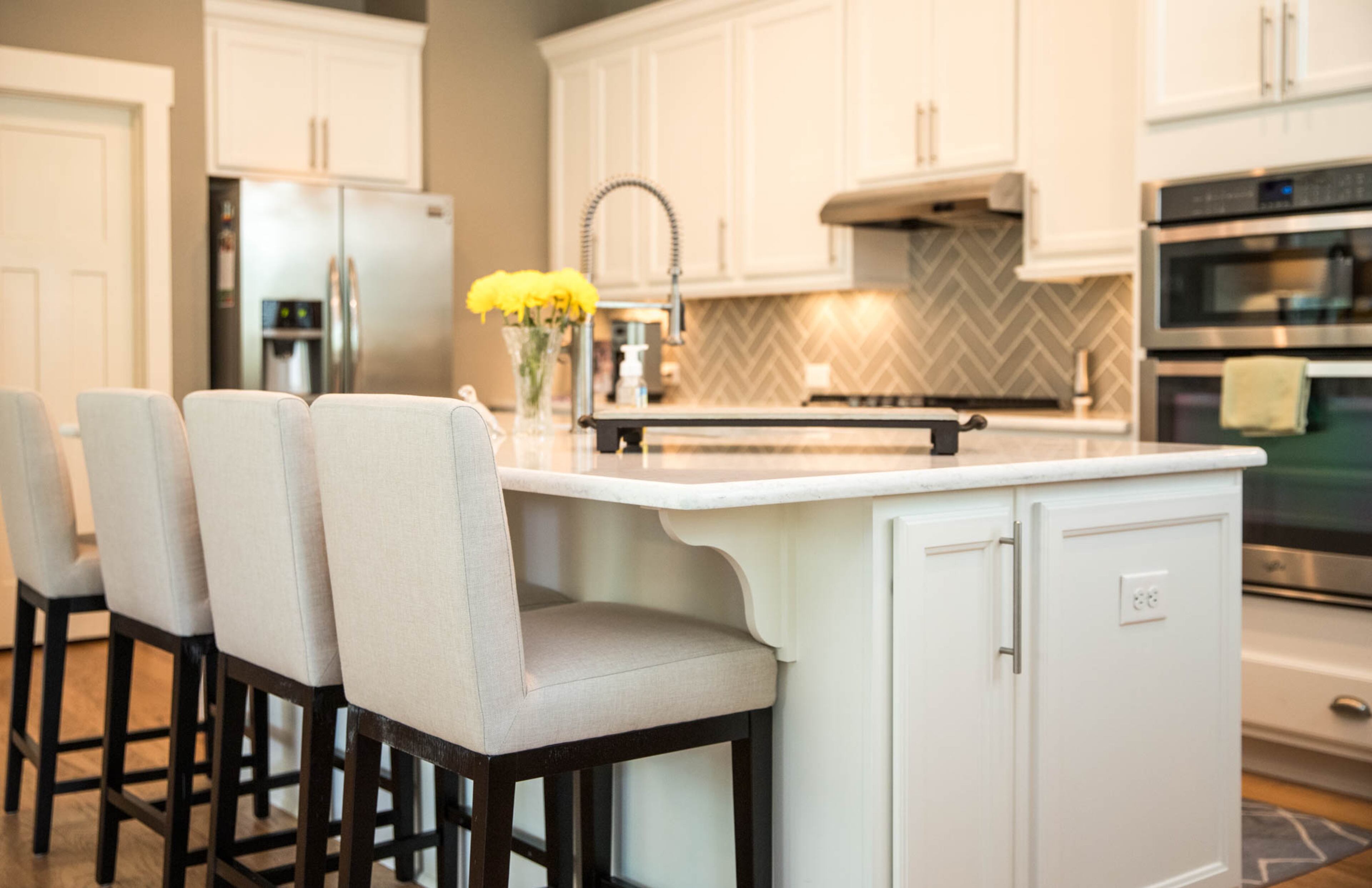 Stools from Macy's make the island of Scott and Patti's kitchen a comfortable gathering place, and the large flat island makes food prep easy while entertaining. Scott, who had a tiered island in his last home, said he appreciates being able to work at the island and converse with folks in the living room and dining area.