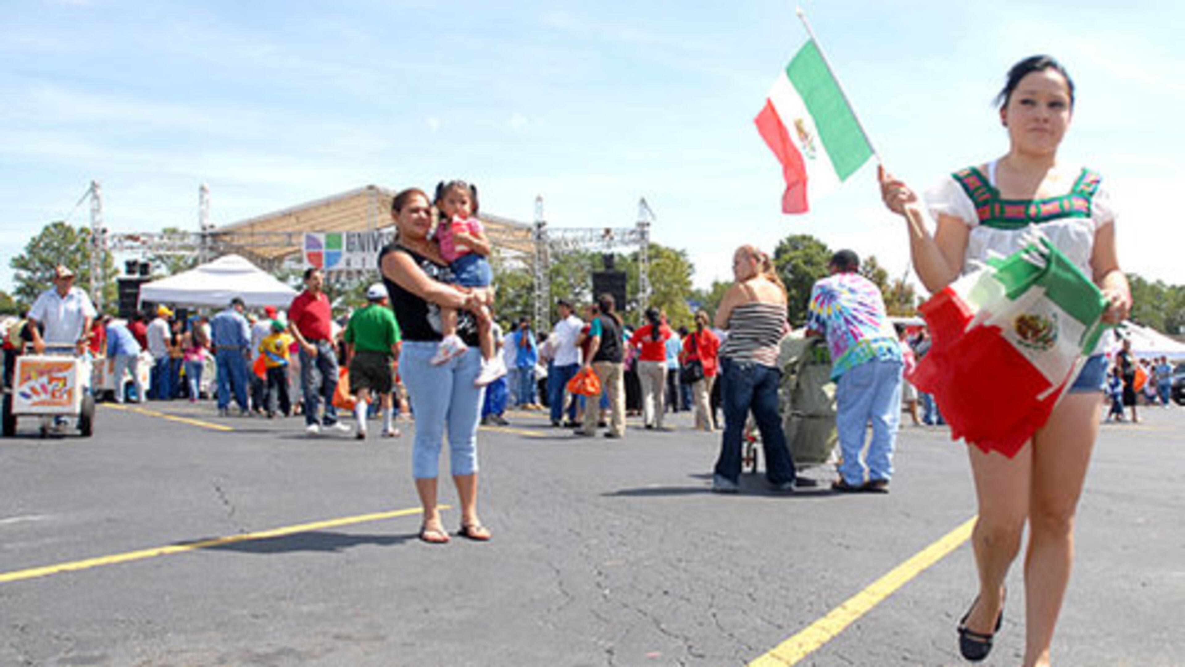 Susana Olague sells Mexican flags during the celebration at Plaza Fiesta.