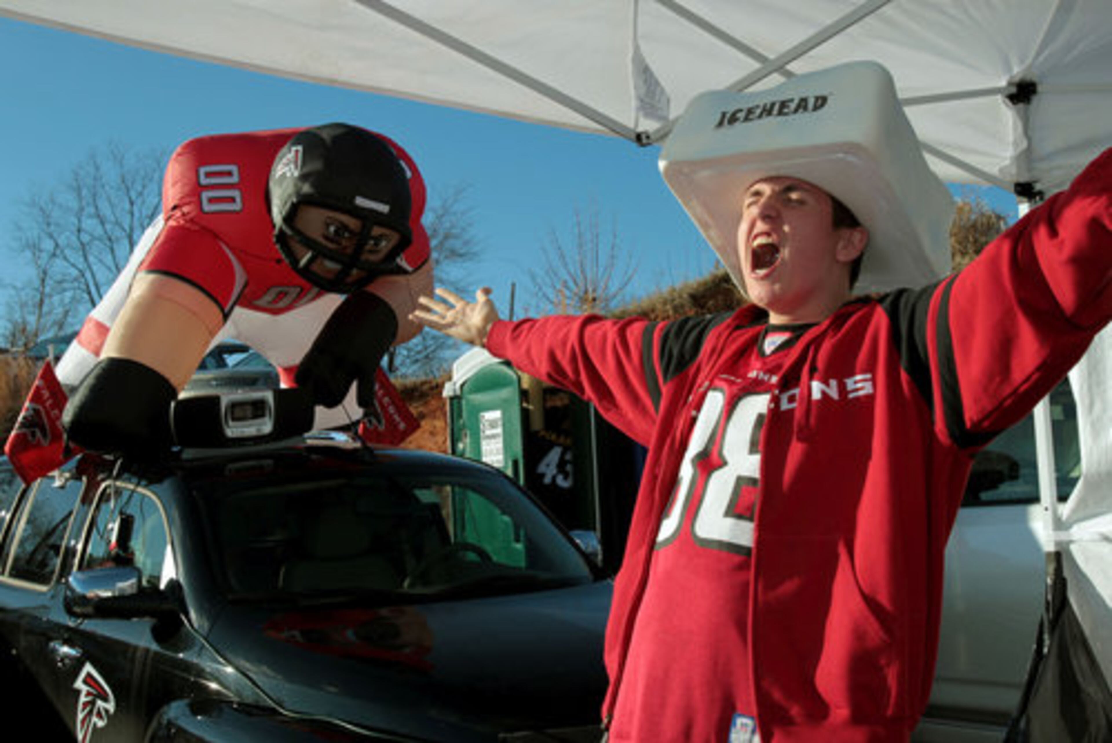 Atlanta Falcon fan Jamie Wiese, of Johns Creek, yells "Rise Up!" as he wears an Icehead hat next to an inflatable Falcons player as he tailgates with family in the parking lot outside of the Georgia Dome Saturday afternoon in Atlanta, Ga., Jan. 15, 2011. The Atlanta Falcons host the Green Bay Packers in their NFC divisional playoff game Saturday night.