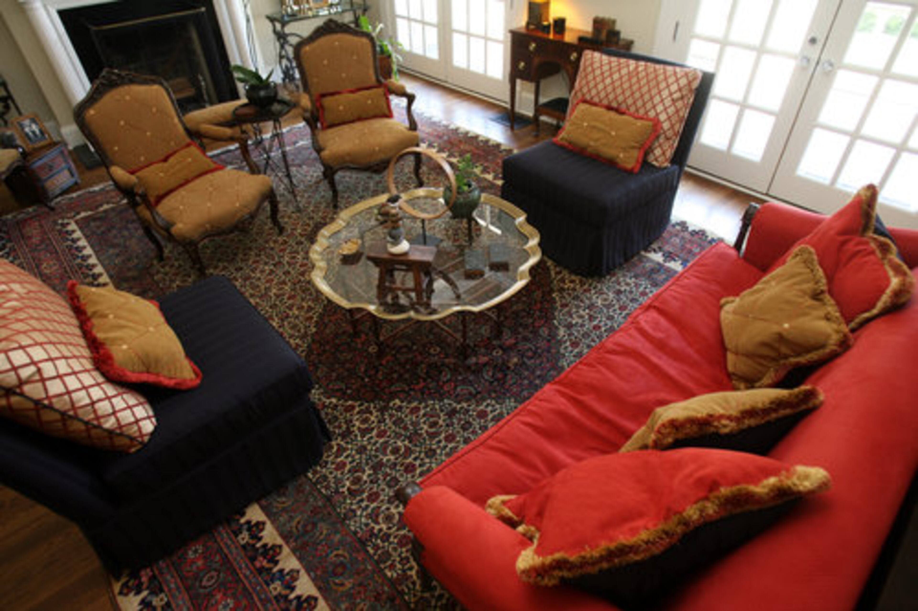 The living room features a bright red sofa.