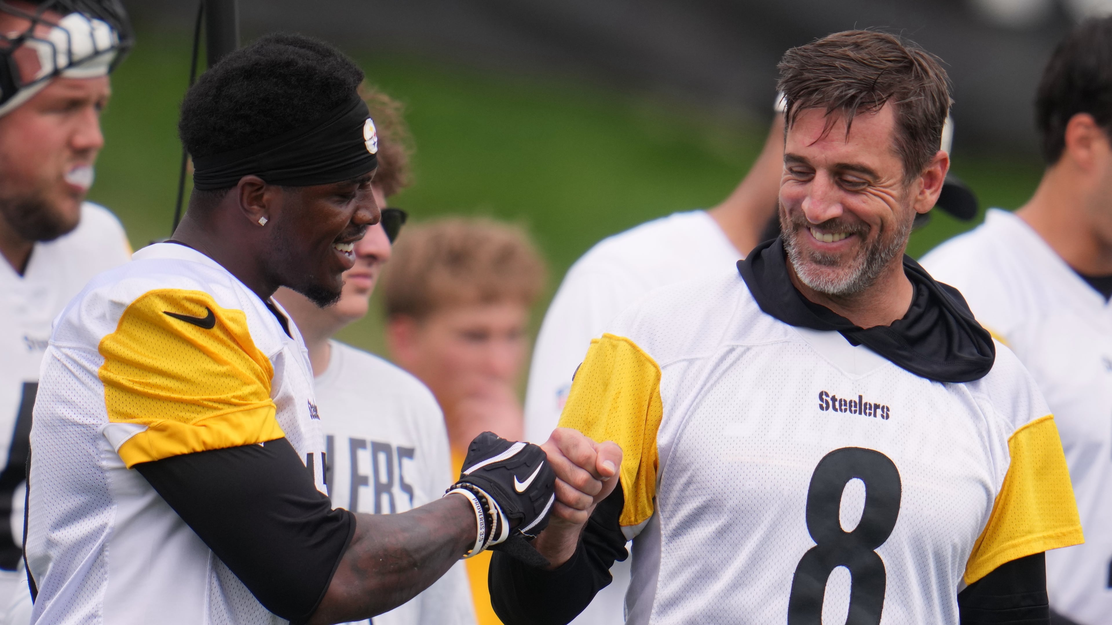 Pittsburgh Steelers quarterback Aaron Rodgers (8) fist bumps wide receiver Germie Bernard, left during the NFL team's training camp in Latrobe, Pa., Saturday, Aug. 1, 2026. (AP Photo/Gene J. Puskar)