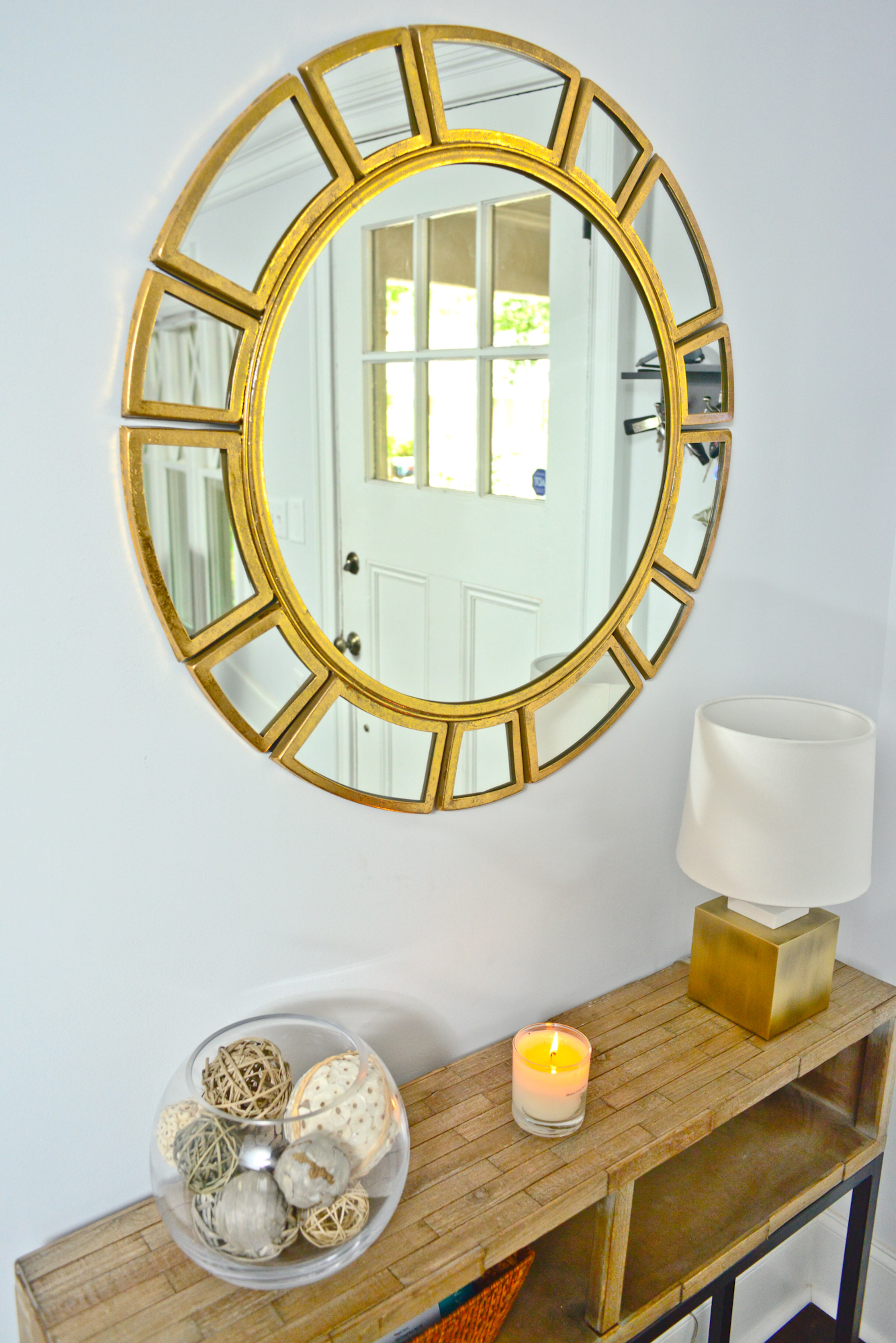 While Megan Isom's and Taqqee Id-Deen's 1935 bungalow was transformed during renovations from a two-bedroom, one-bath to a three-bedroom, three-bath home the front of the house is structurally the same. The foyer mirror reflects the irreplaceable charm of the original front door.
