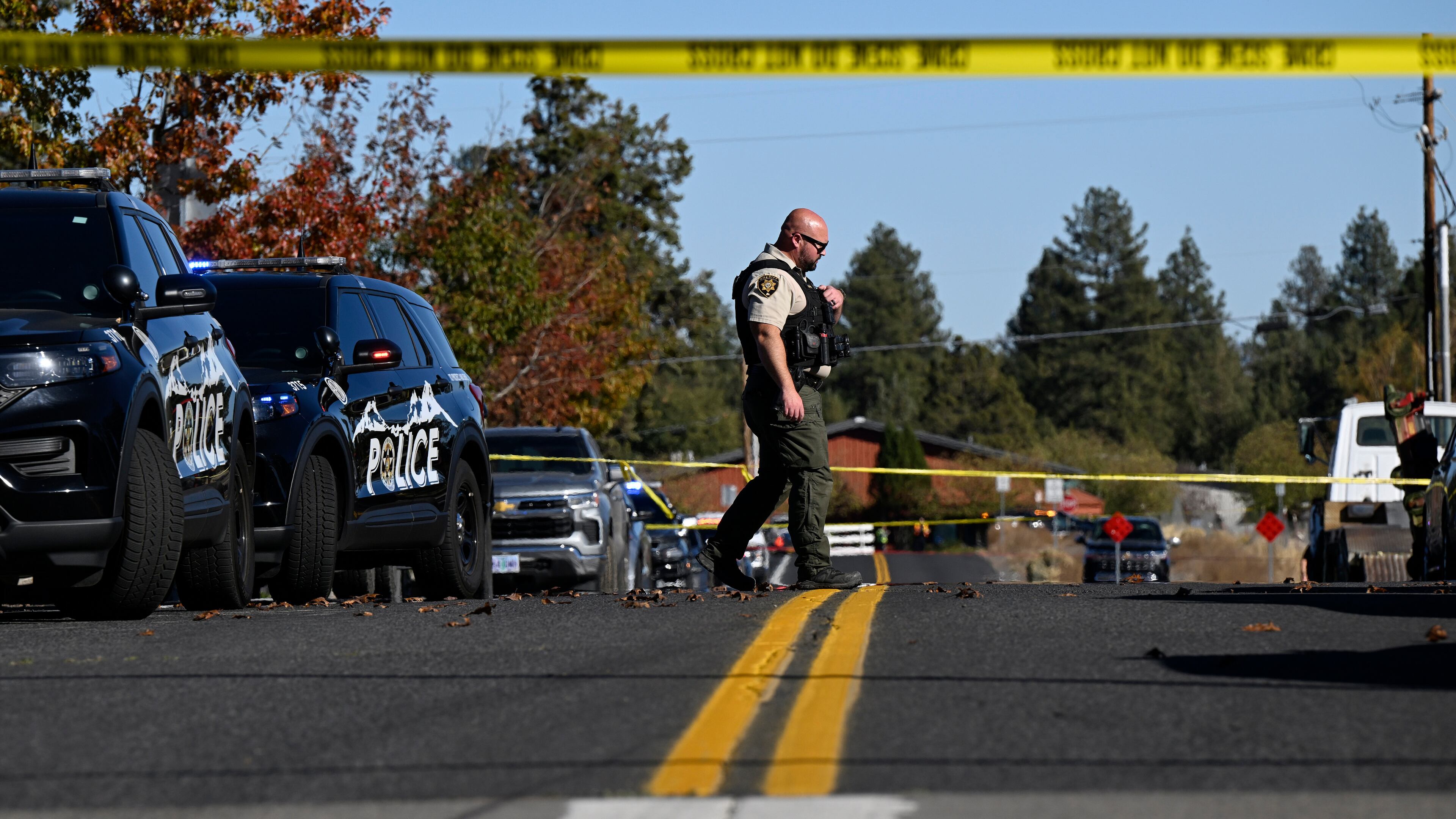 A sheriff's deputy walks outside Silver Rail Elementary school, where a shooting took place, on Thursday, Oct. 15, 2026 in Bend, Ore. (AP Photo/Joe Kline)