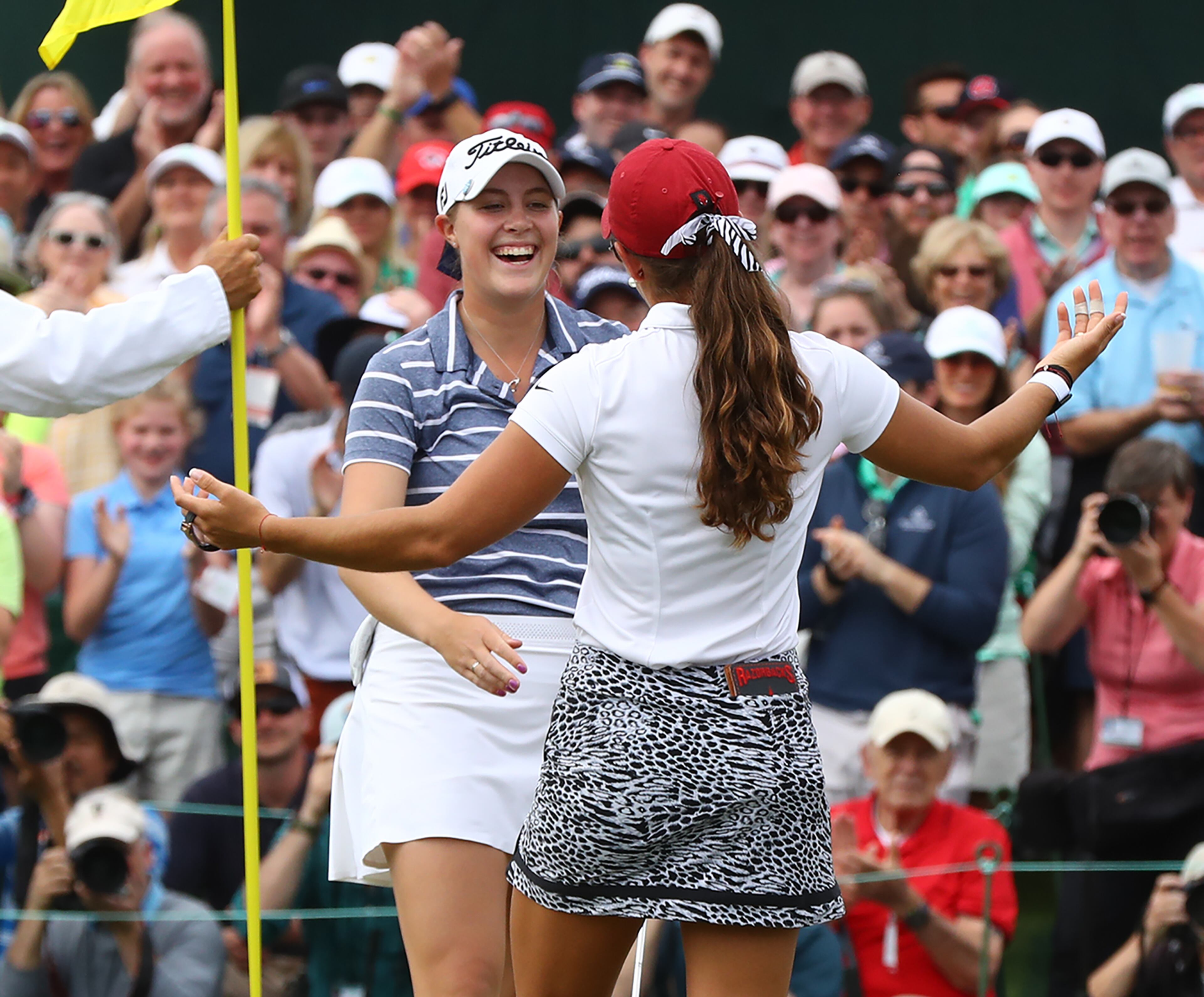 Augusta National Women's Amateur winner Jennifer Kupcho (left) gets ready to hug it out with runner-up Maria Fassi on No. 18. (Curtis Compton/ccompton@ajc.com)