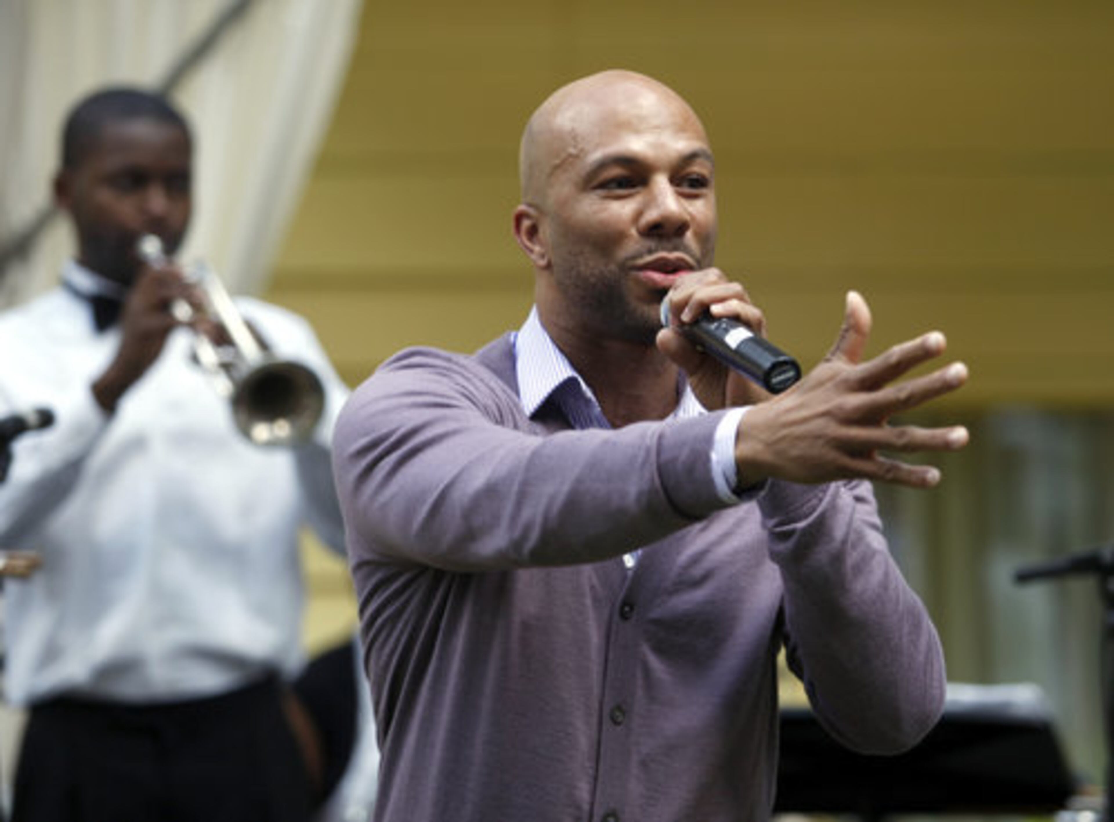 Hip hop performer Common raps for poet Maya Angelou at a garden party.