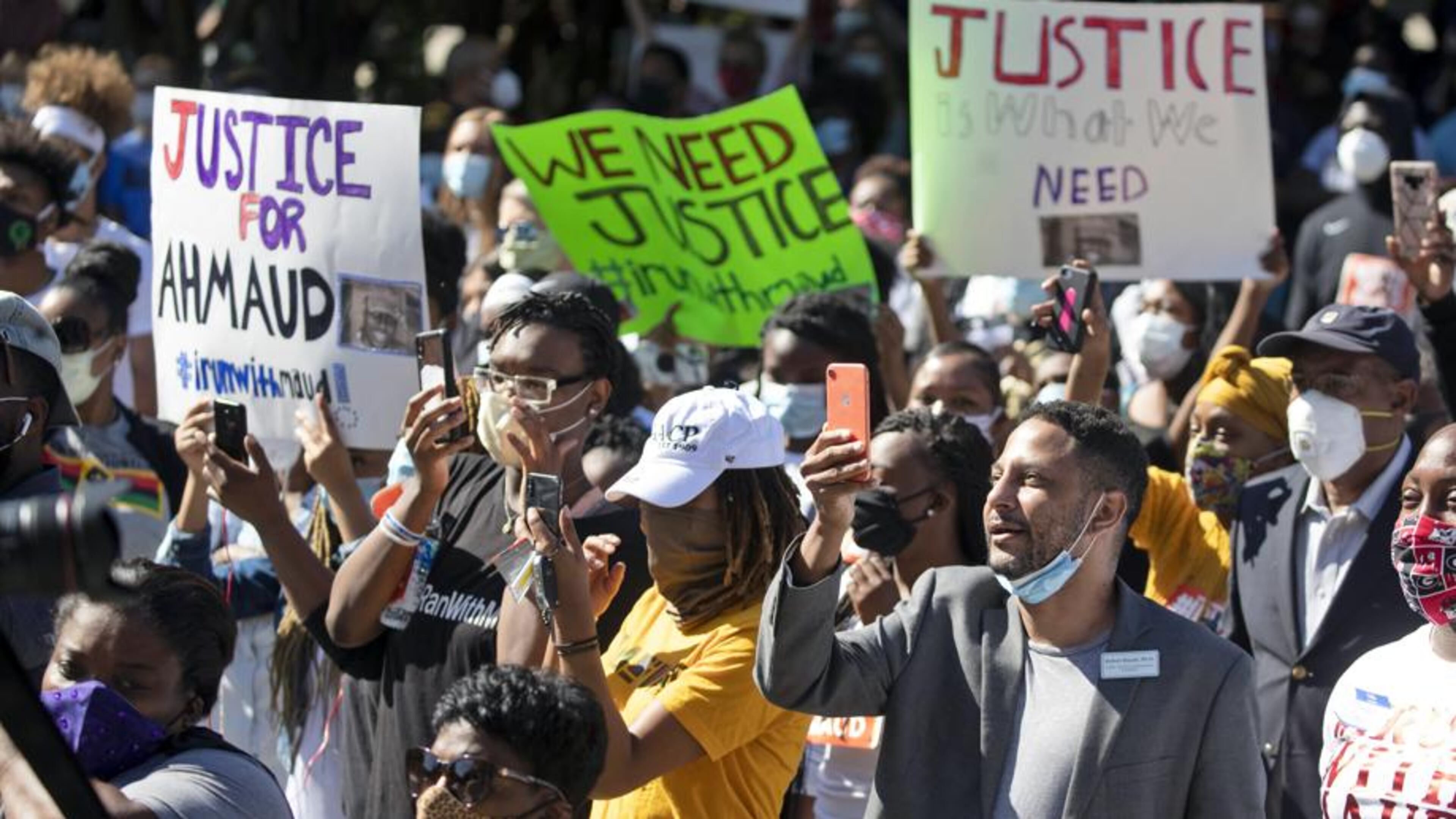 People react during a rally to protest the shooting of Ahmaud Arbery, an unarmed black man Friday, May 8, 2020, in Brunswick Ga. Two men have been charged with murder in the February shooting death of Arbery, whom they had pursued in a truck after spotting him running in their neighborhood. (AP Photo/John Bazemore)