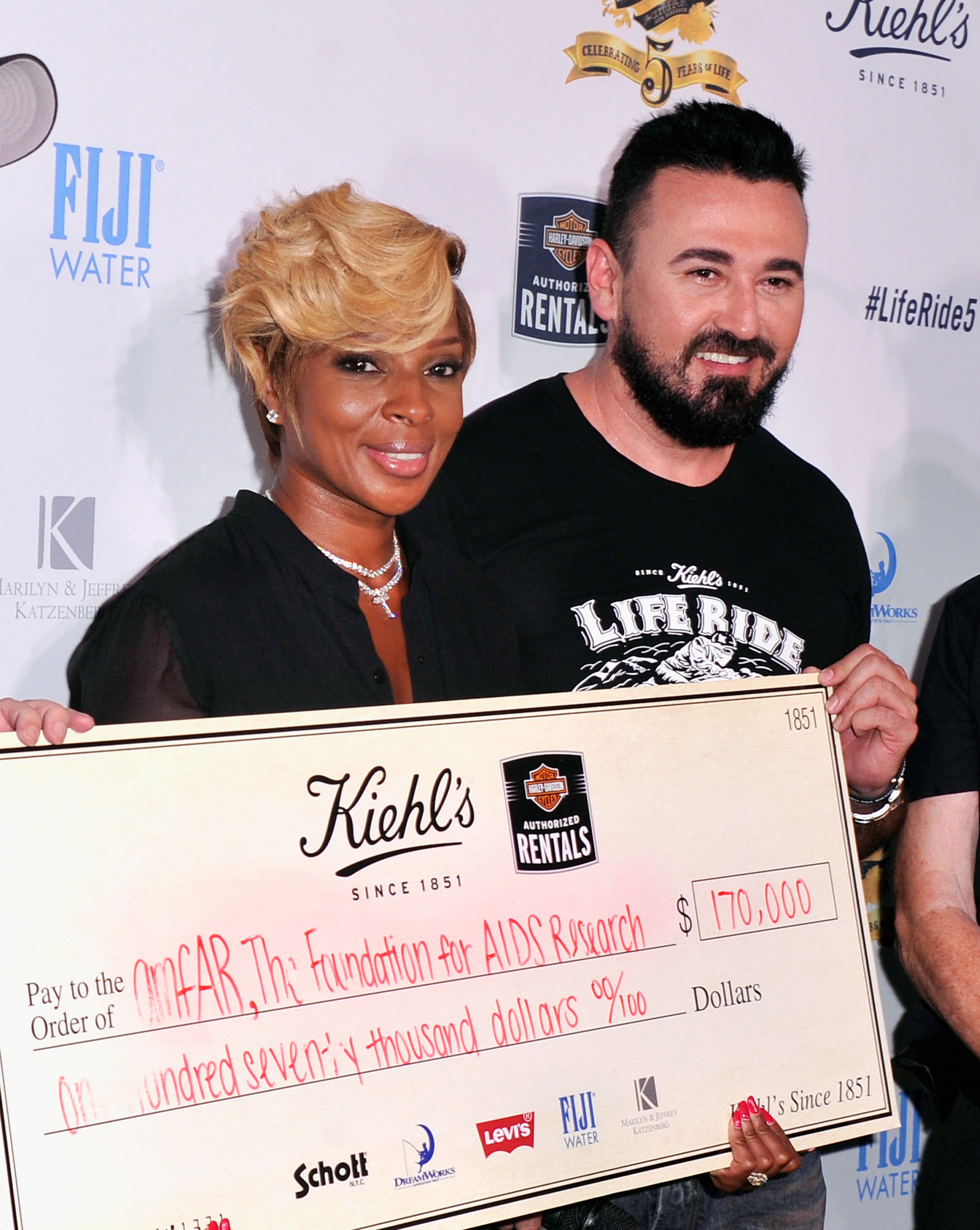 NEW YORK, NY - AUGUST 12: Mary J. Blige (L) and President, Kiehl's USA Chris Salgardo attend Kiehl's LifeRide for amfAR co-hosted by FIJI Water on August 12, 2014 in New York City. (Photo by Stephen Lovekin/Getty Images for FIJI Water)