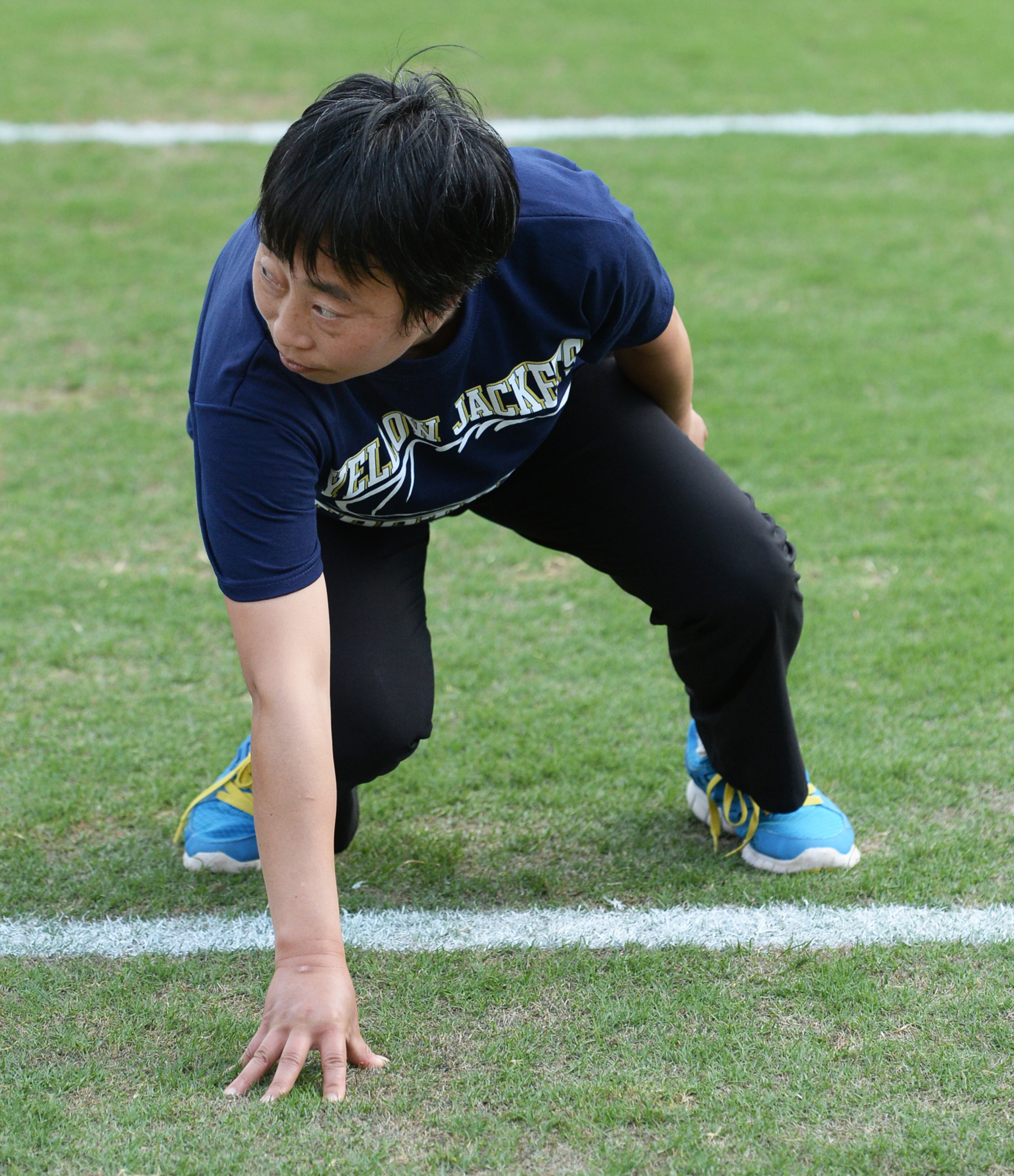 Zhu Chen, China, gets in the three point stand during Georgia Tech's International Football Clinic on Thursday, April 18, 2013.