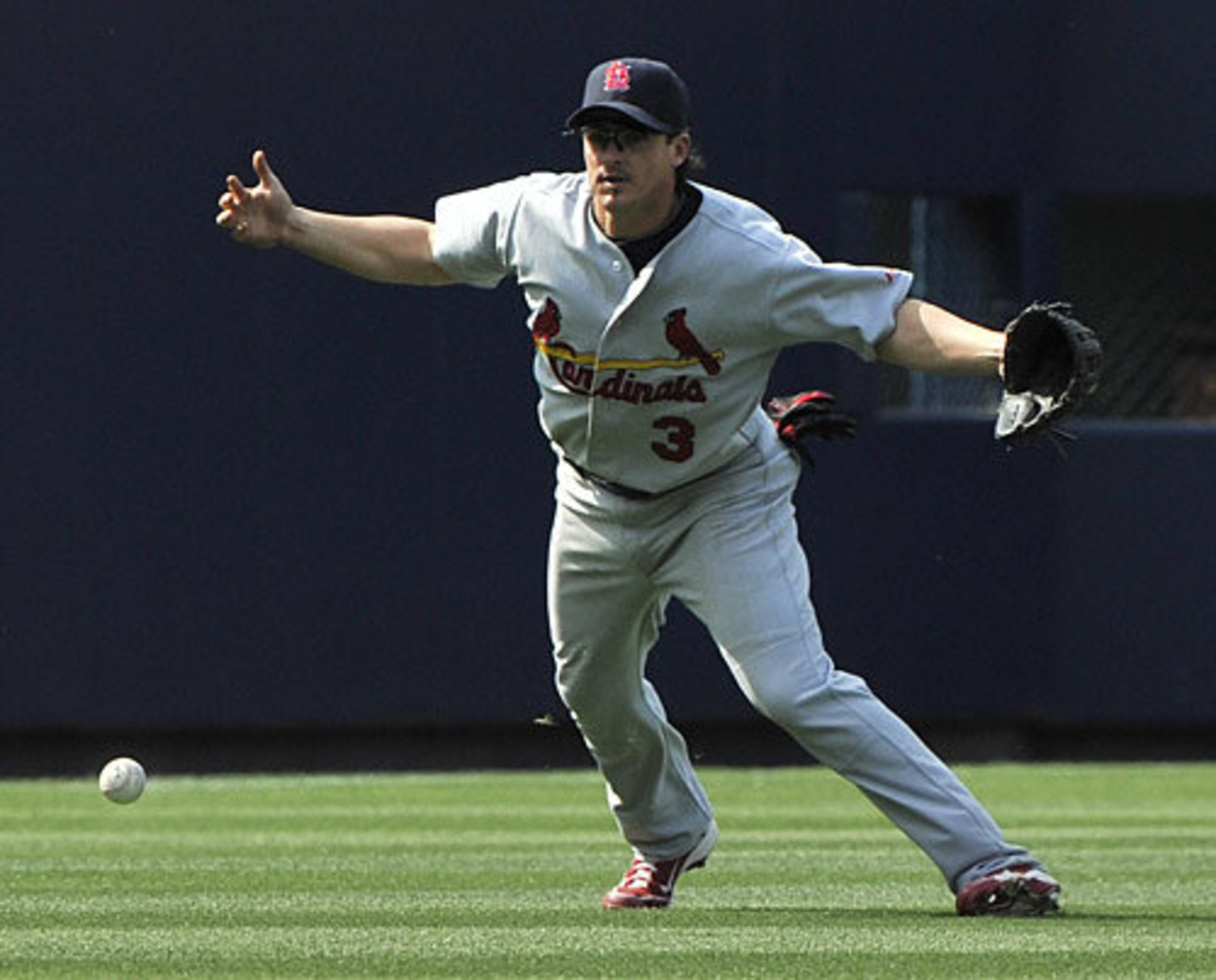 Cardinals shortstop Ryan Theriot drops a fly in left field off the bat of Atlanta's Alex Gonzalez for an error during the ninth inning.