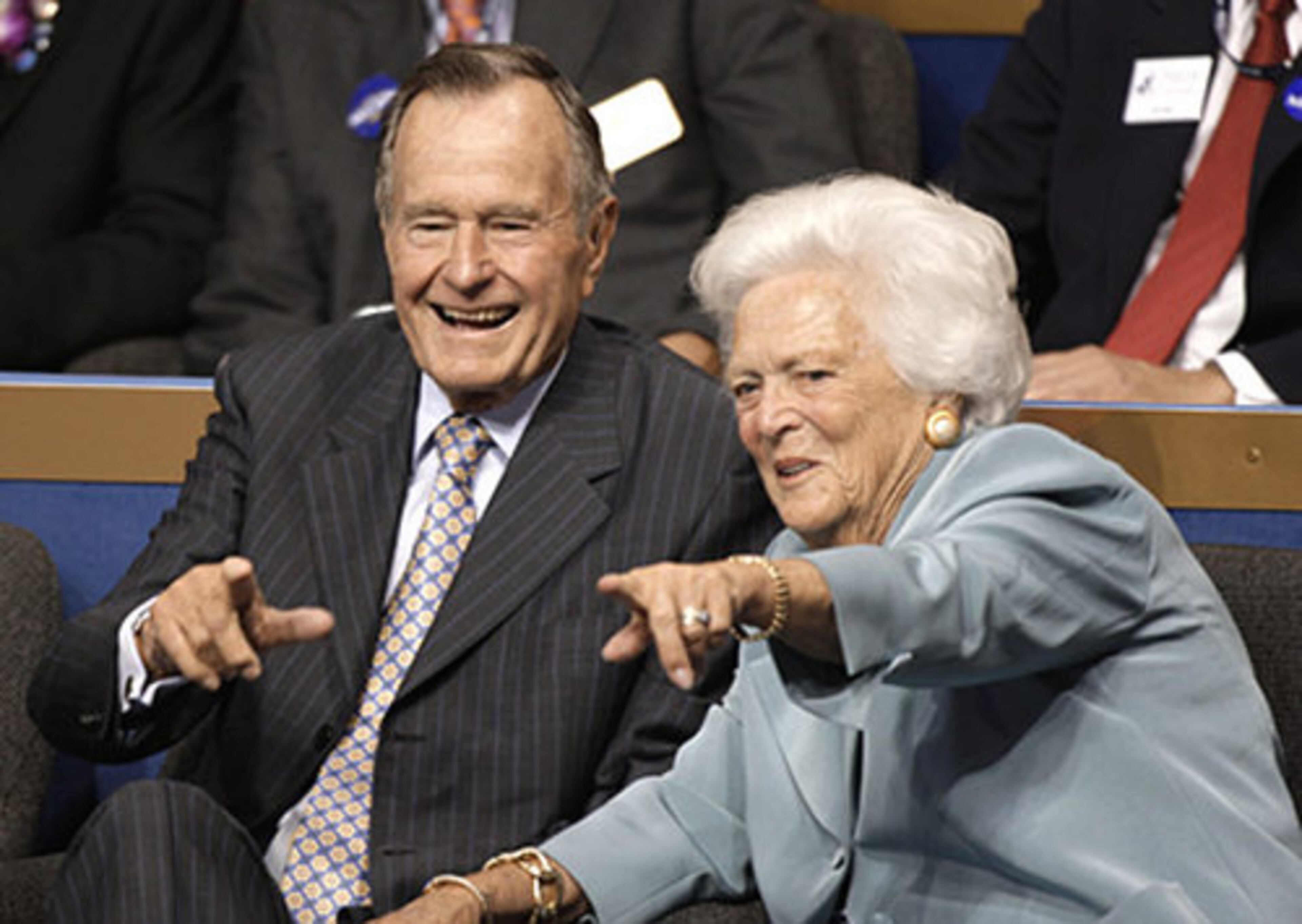 Former President George Bush and former first lady Barbara Bush greet the crowd as they arrive at the convention Tuesday night.