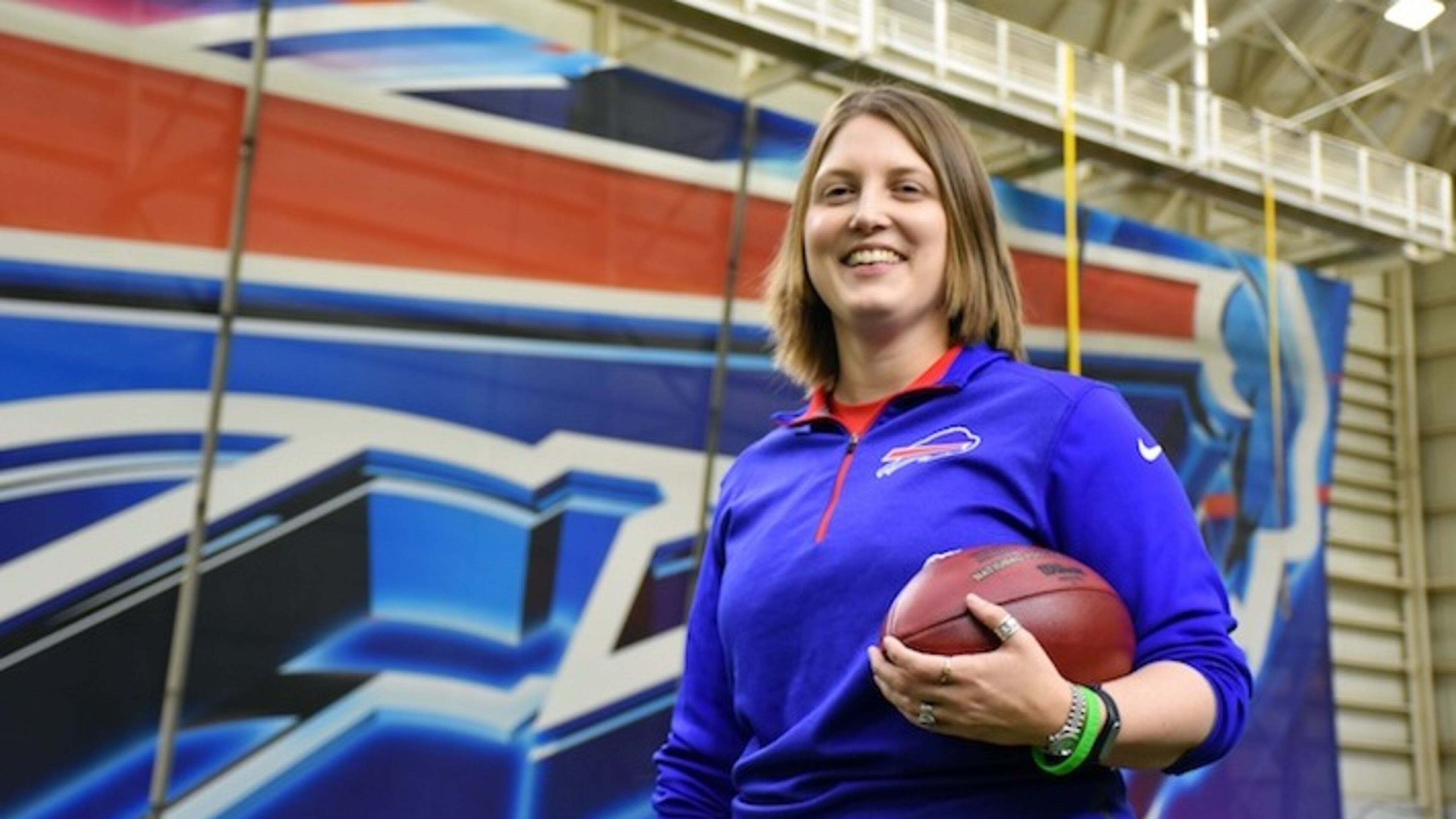 In this photo provided by the Buffalo Bills, Bills assistant football coach Kathryn Smith poses, Thursday, Jan. 21, 2016, in Orchard Park, N.Y. Smith is the first, full time, female assistant coach in the National Football League. (Anna Stolzenberg/Buffalo Bills via AP)