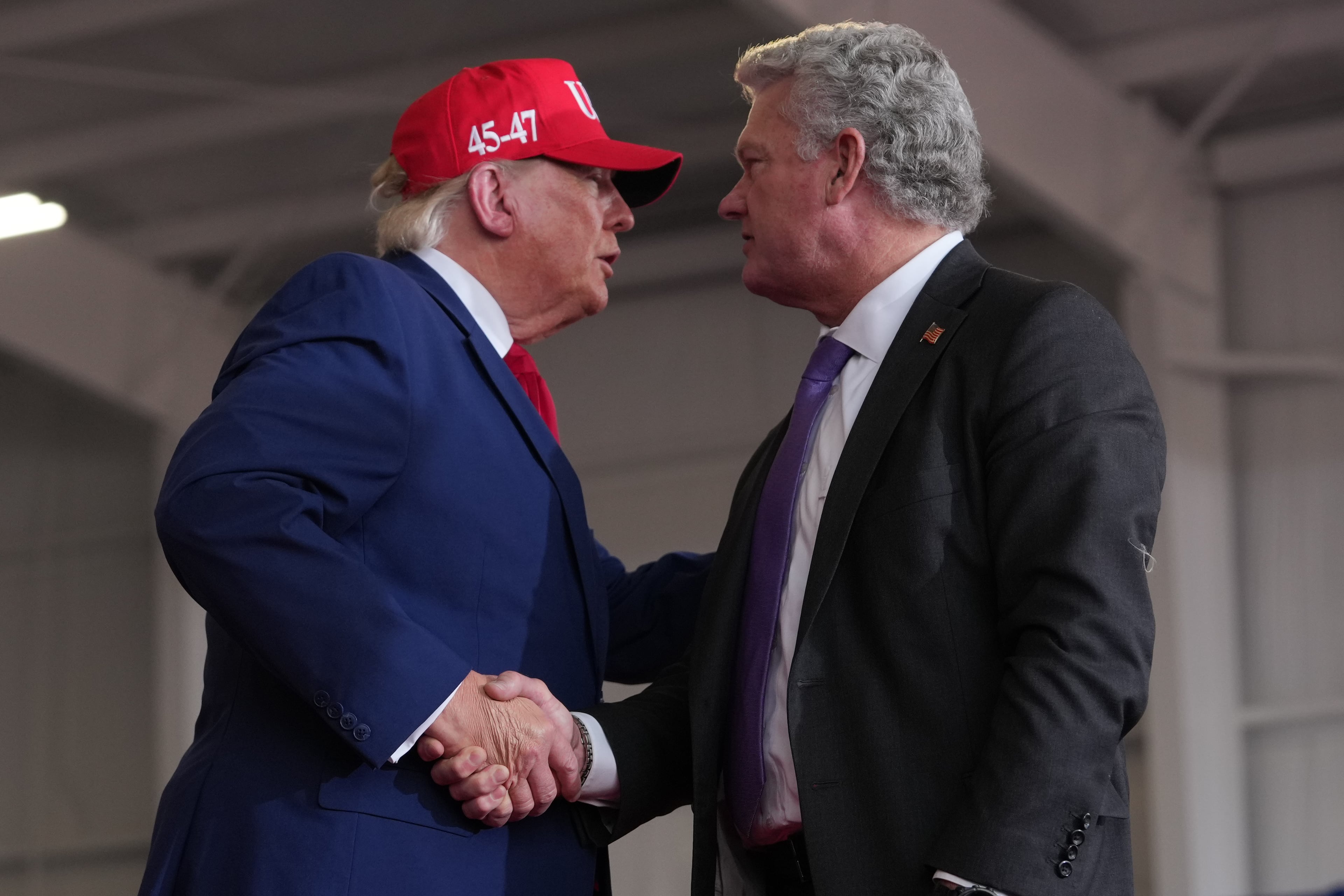 President Donald Trump shakes hands with Georgia Republican U.S. Senate nominee Mike Collins at a campaign rally in Dalton last week. (Mark Schiefelbein/AP)