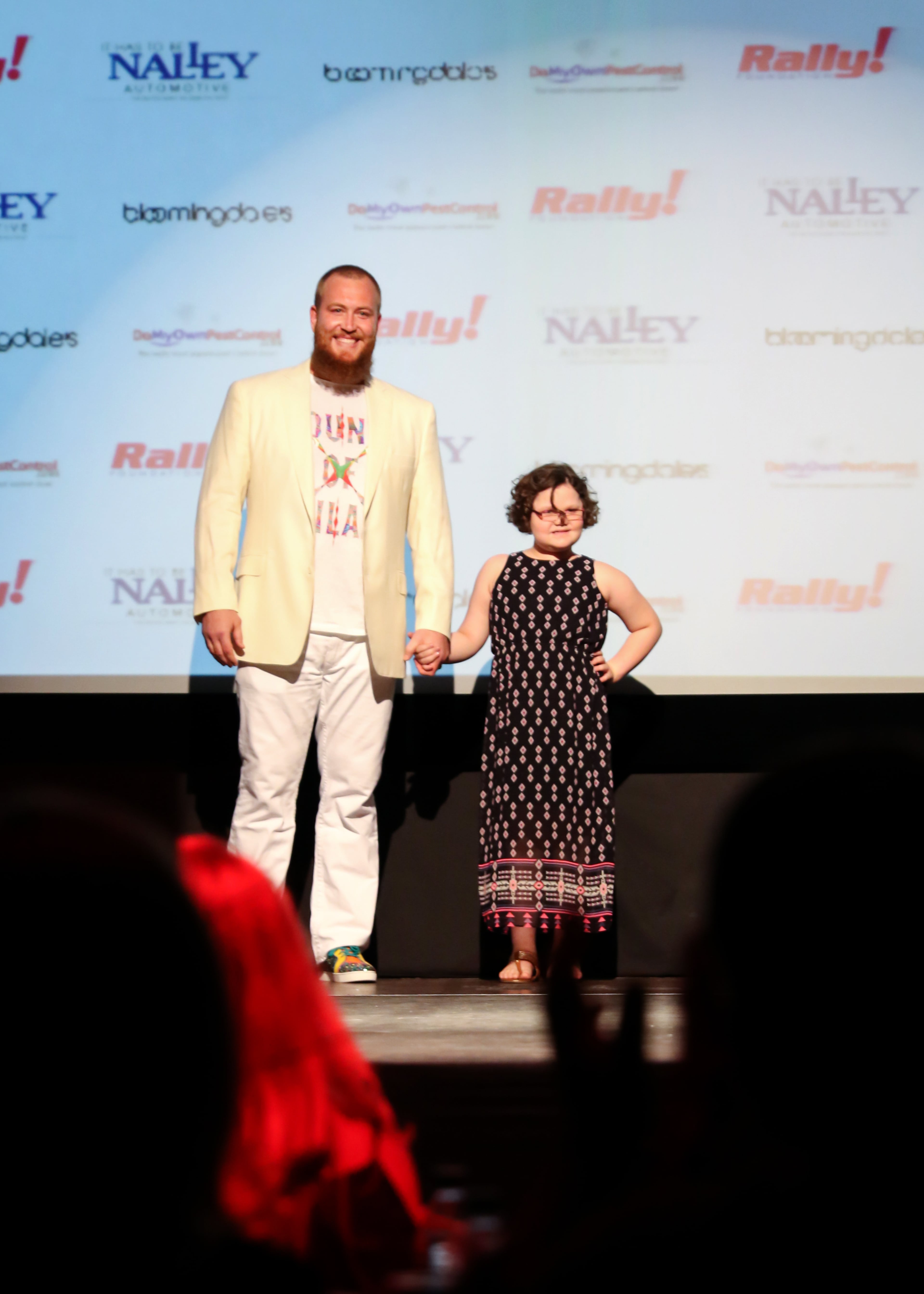 Atlanta Falcons left tackle Sam Baker escorts Elizabeth in the 6th annual Rally on the Runway fashion show at the Buckhead Theatre on Friday, April 24, 5015. The event helped raise $200,000 for the Rally Foundation for Childhood Cancer Research. Photography by Lauren Chambers.