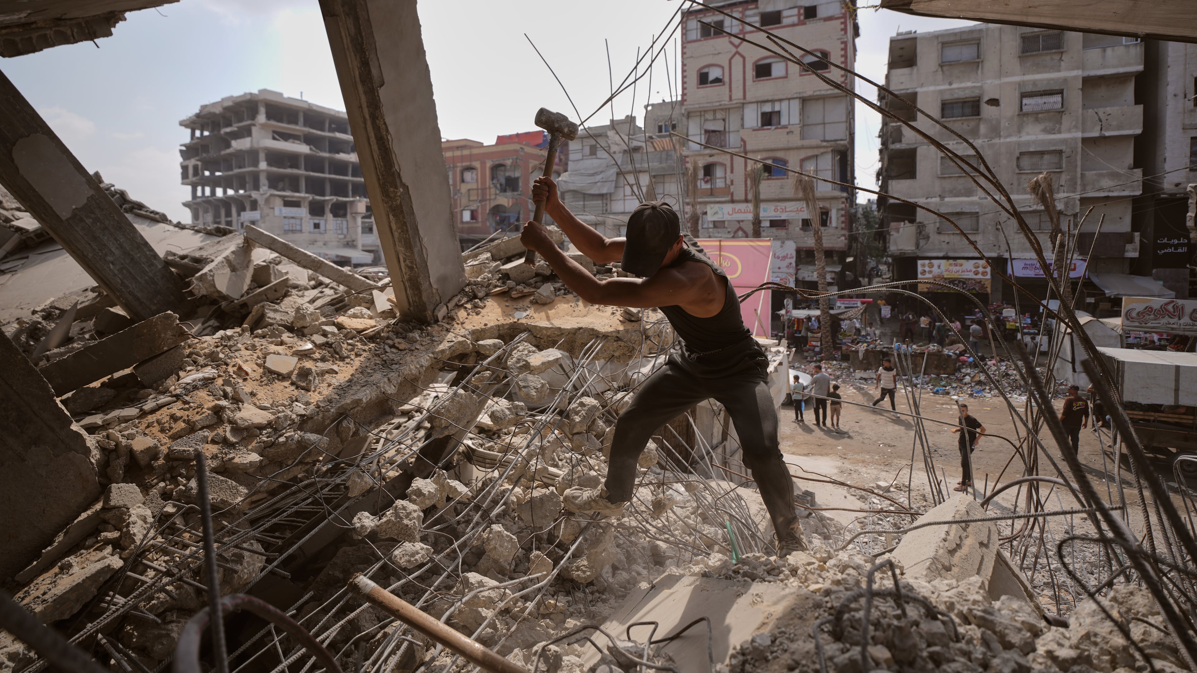 Palestinians remove iron from the rubble of buildings destroyed by Israeli airstrikes during the war with Hamas, repair and recycle it for construction, building tents or selling it, in Gaza City, Sunday, Aug. 16, 2026. (AP Photo/Jehad Alshrafi)