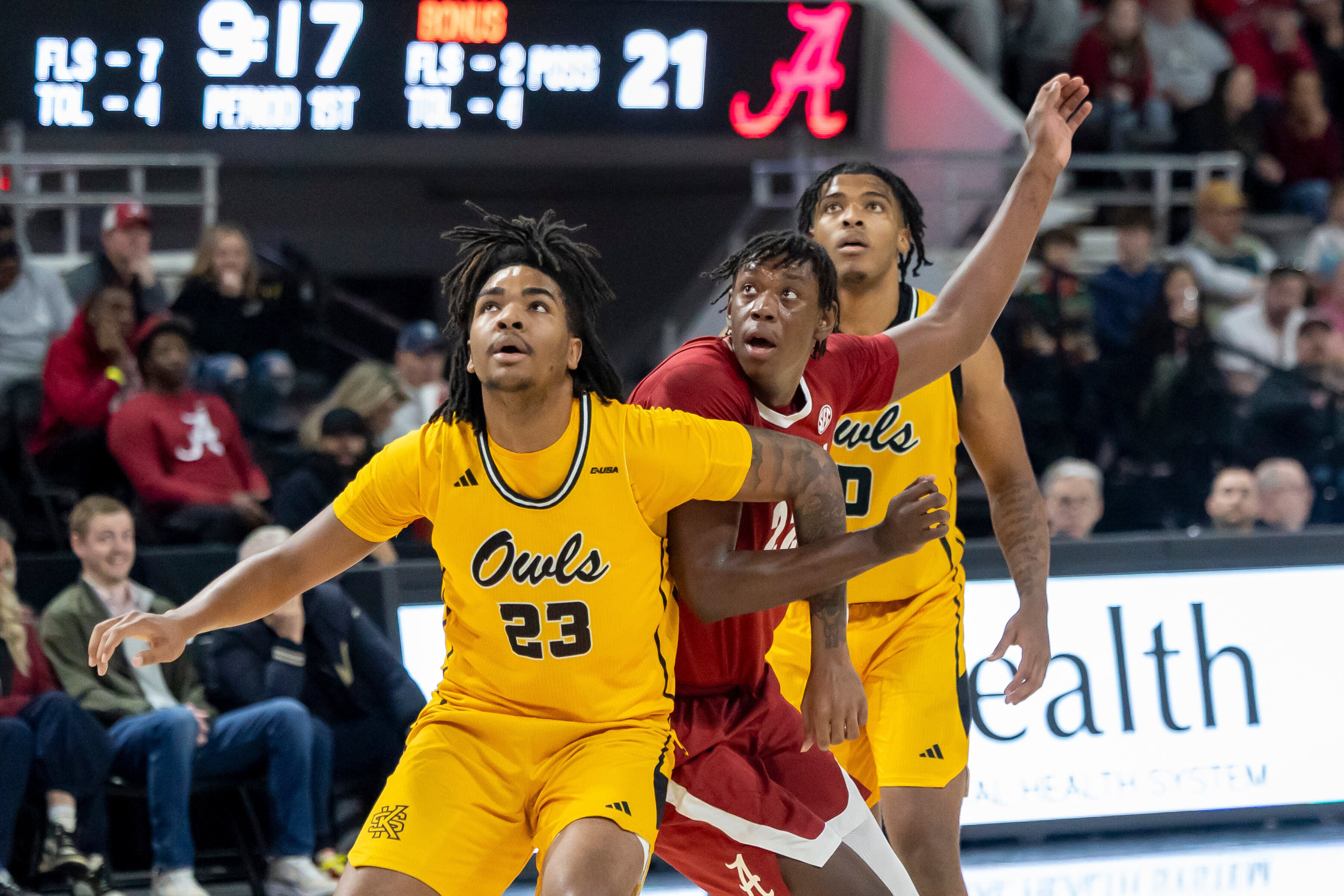 Kennesaw State's Amir Taylor (left) and Alabama's Aiden Sherrell (center) work under the basket Sunday, Dec. 21, 2025, in Huntsville, Ala. (Vasha Hunt/AP)