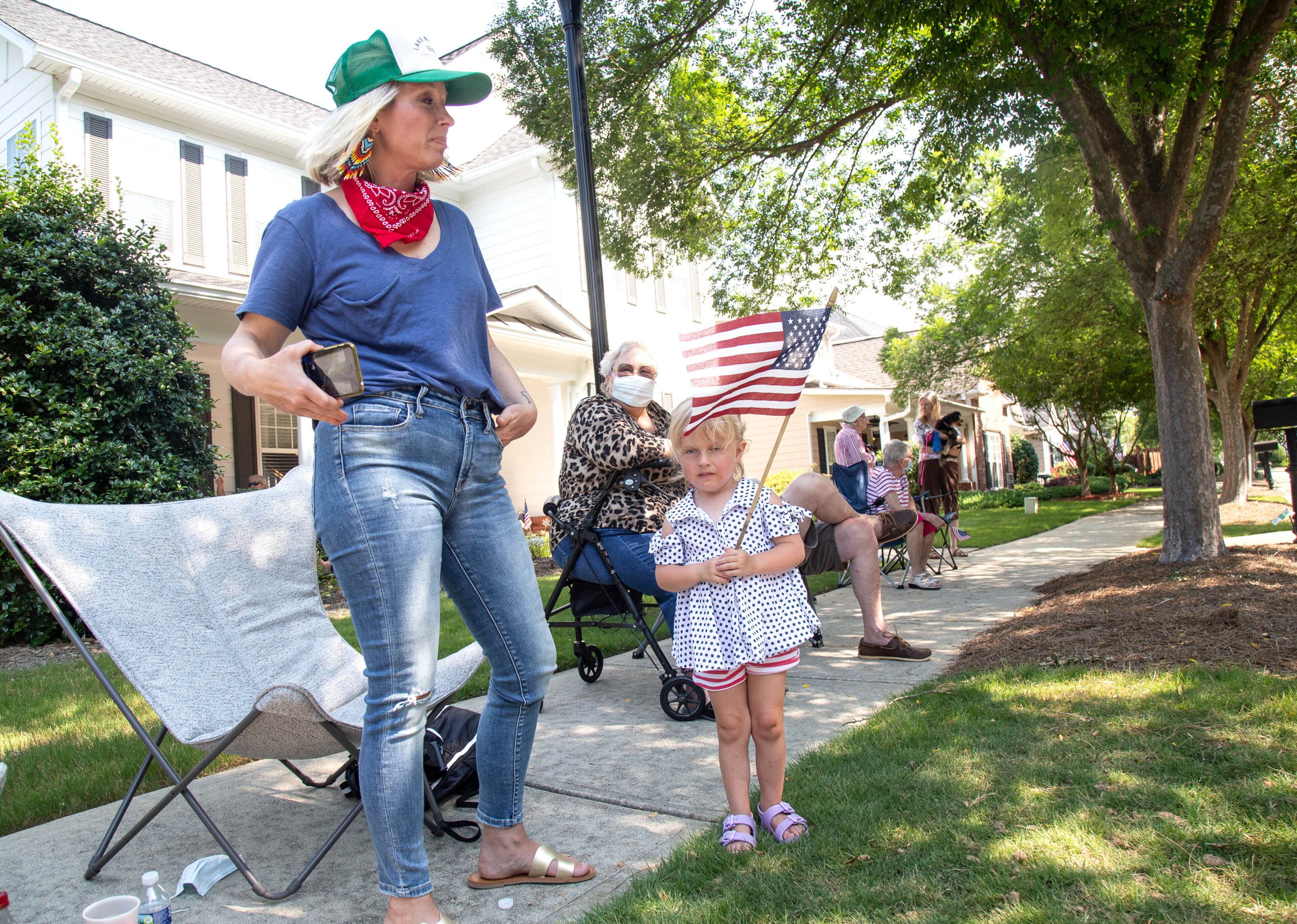 Jennifer Fitzgerald (L) and her daughter Vivian, 3, watches the 4th of July drive-by parade in Powder Springs on Saturday, July 4, 2020. The cars drove through different neighborhoods during an hour and a half parade through the community.
STEVE SCHAEFER FOR THE ATLANTA JOURNAL-CONSTITUTION